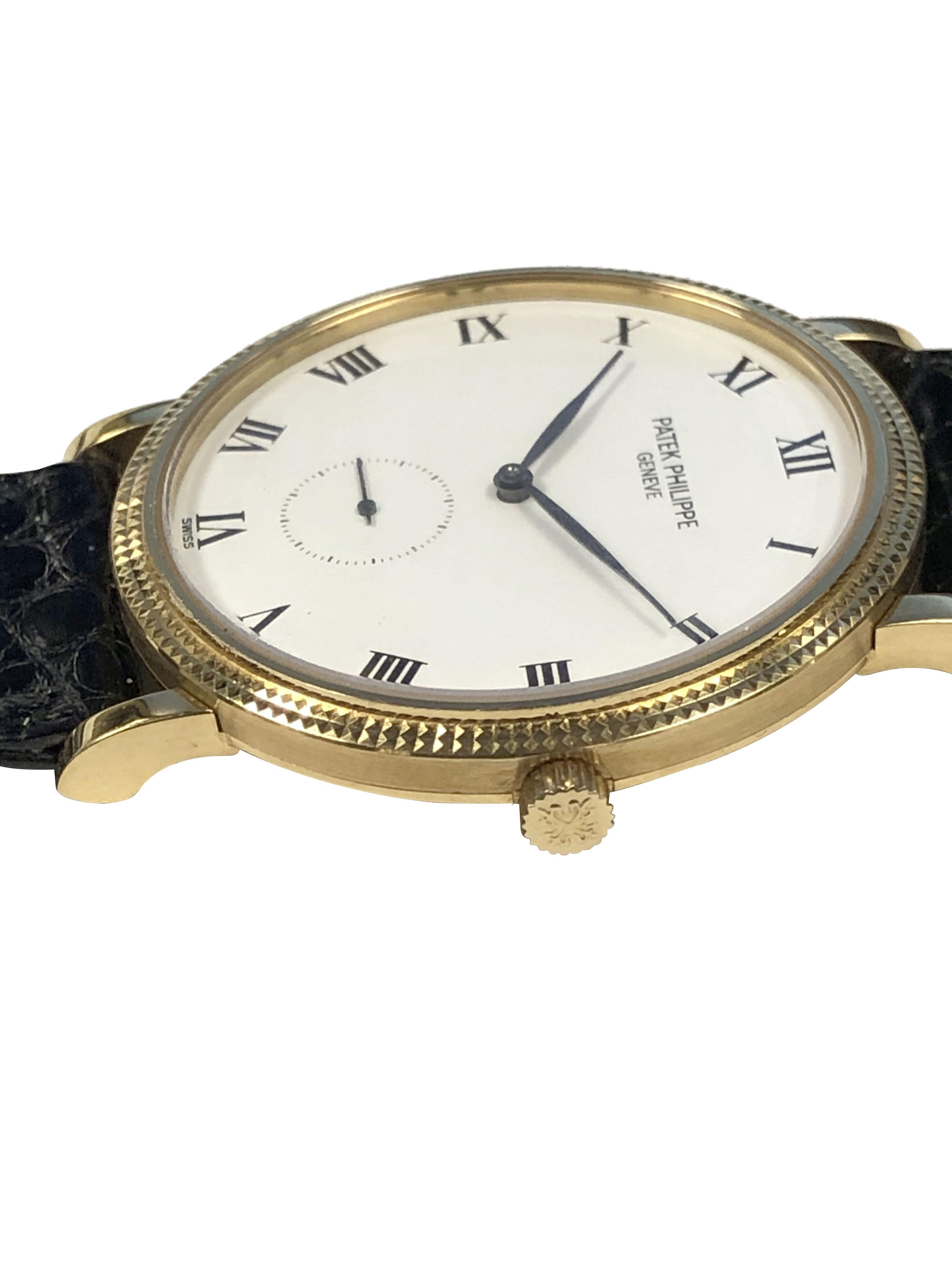 Circa 1996 Patek Philippe Calatrava reference 3919 Wrist Watch, 33 M.M. 18k Yellow Gold 2 piece case with Hobnail bezel. Caliber 215 18 Jewel Mechanical, Manual wind movement. White Enamel Dial with Black Roman Numerals and a sub seconds hand.