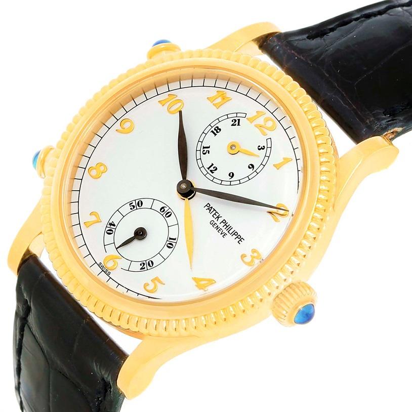 Patek Philippe Calatrava Travel Time Yellow Gold Ladies Watch. Model 4864J. Year 2000. Manual winding movement. Stamped with the Seal of Geneva Quality Mark, rhodium-plated, fausses cotes decoration, straight-line lever escapement, Glucydur Gyromax