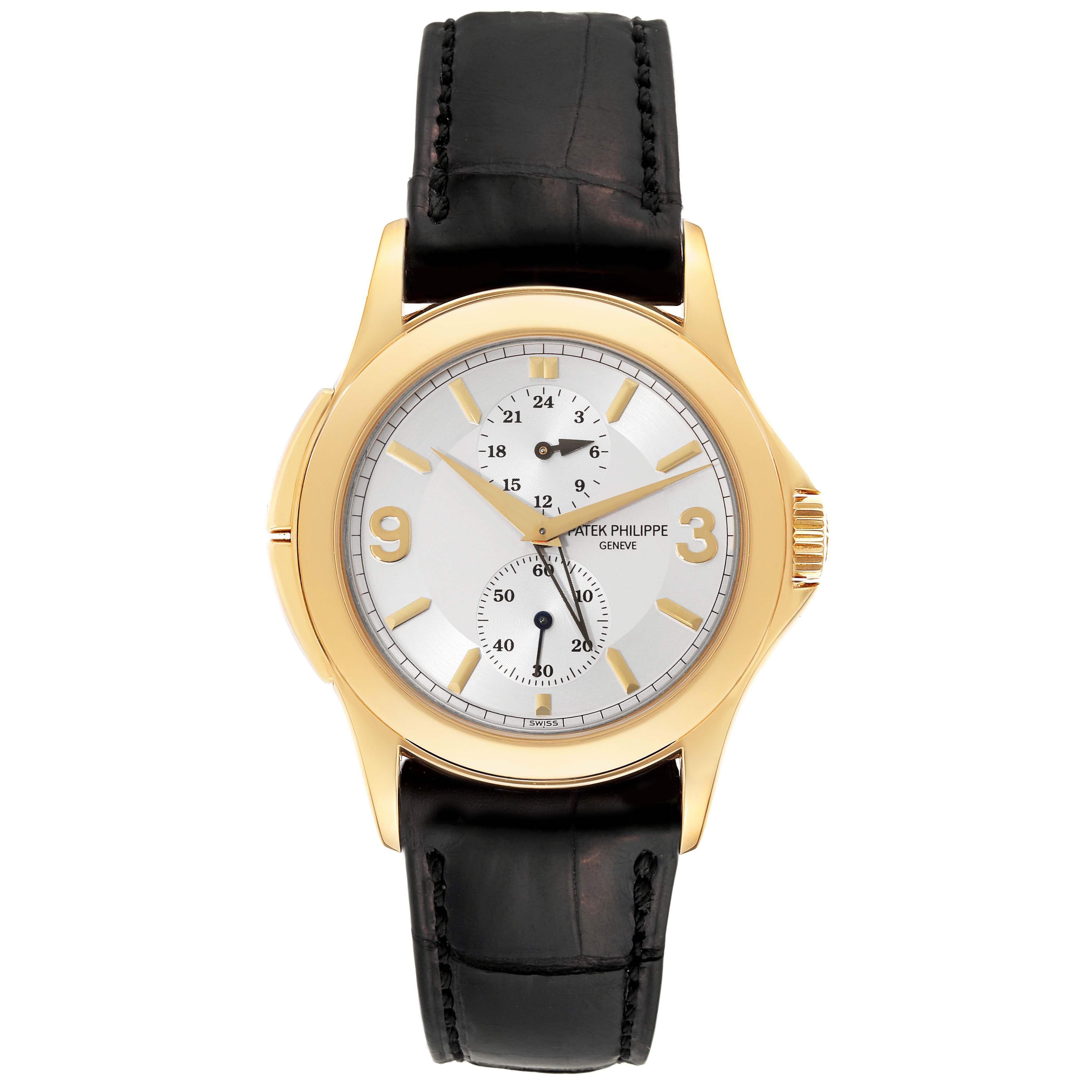 Patek Philippe Calatrava Travel Time Yellow Gold Mens Watch 5134. Manual winding movement. 18k yellow gold case 37.0 mm in diameter. Crown with protective shoulders, pusher at 10 and 8 o'clock to change time zone. Screw-down transparent exhibition