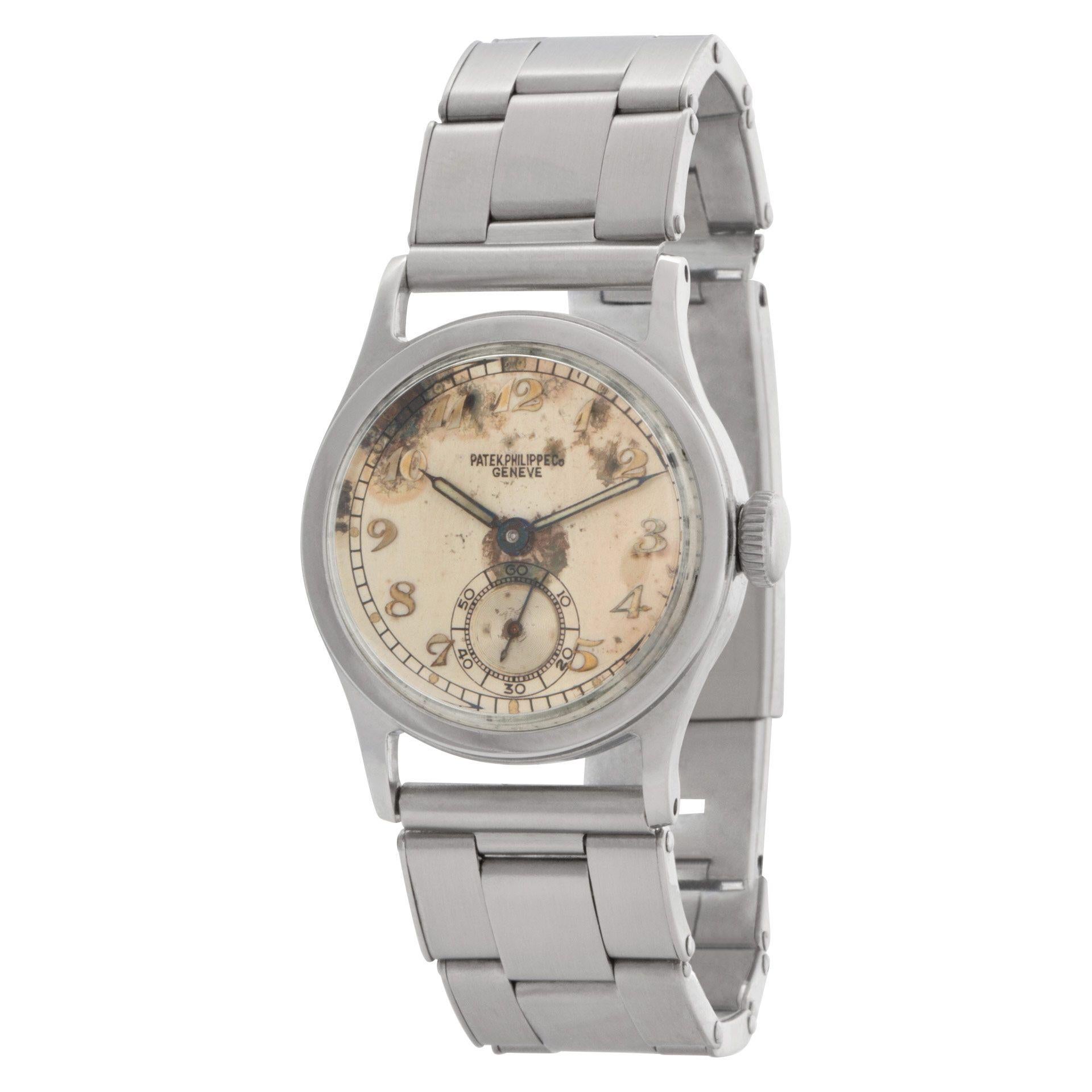 An extremely rare, boy-sized Patek Philippe Calatrava ref 438 in stainless steel, circa 1944, with a case diameter of 28mm (not including the crown). This manual wind watch features unique Arabic numerals, a beautifully aged dial, and radium indexes