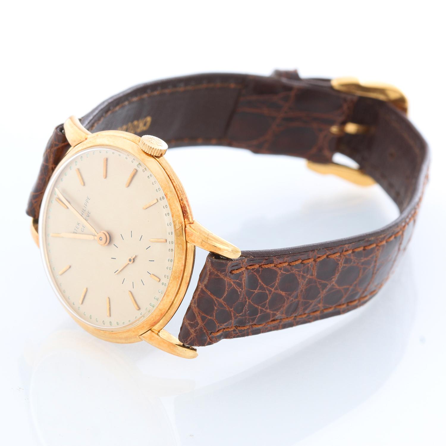 Patek Philippe & Co. 18K Yellow Gold  Calatrava Ref -  2484 - Manual winding. 18K Yellow Gold ( 32 mm ). Silver dial with raised gold hour markers and subdial at 6 o'clock. Brown leather strap with tang buckle. Pre-owned with custom box. Circa