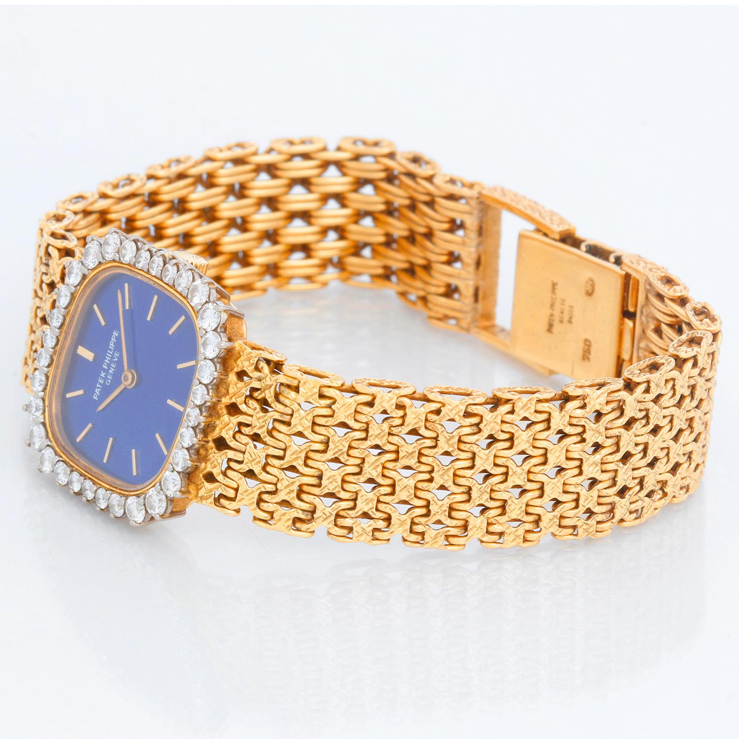 Patek Philippe & Co. 18K Yellow Gold Ref 4181 Ladies' Watch - Manual. 18K Yellow gold with diamond bezel ( 23 mm x 29 mm ). Blue dial with applied gold baton markers. Patek Philippe link bracelet with fold over clasp. Measures 6 1/2 inch wrist.