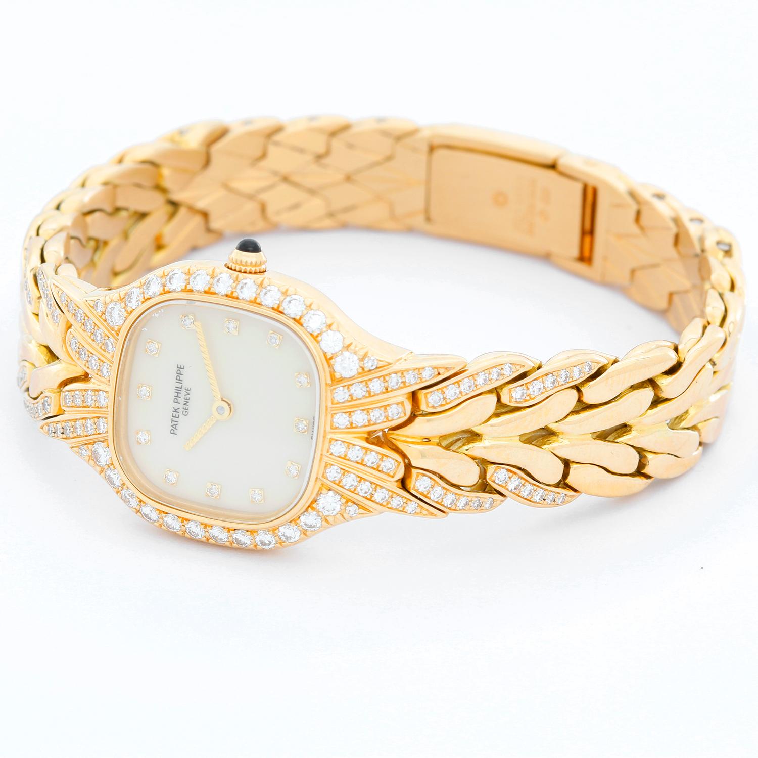 Patek Philippe & Co. La Flamme 18K Yellow Gold Watch Ref 4815 - Quartz. 18K Yellow Gold  with diamond bezel ( 22 x 27 mm ). Ivory dial with diamond hour markers. 18K Yellow Gold bracelet with partial diamond bracelet. Will fit approx 6 1/2 inch