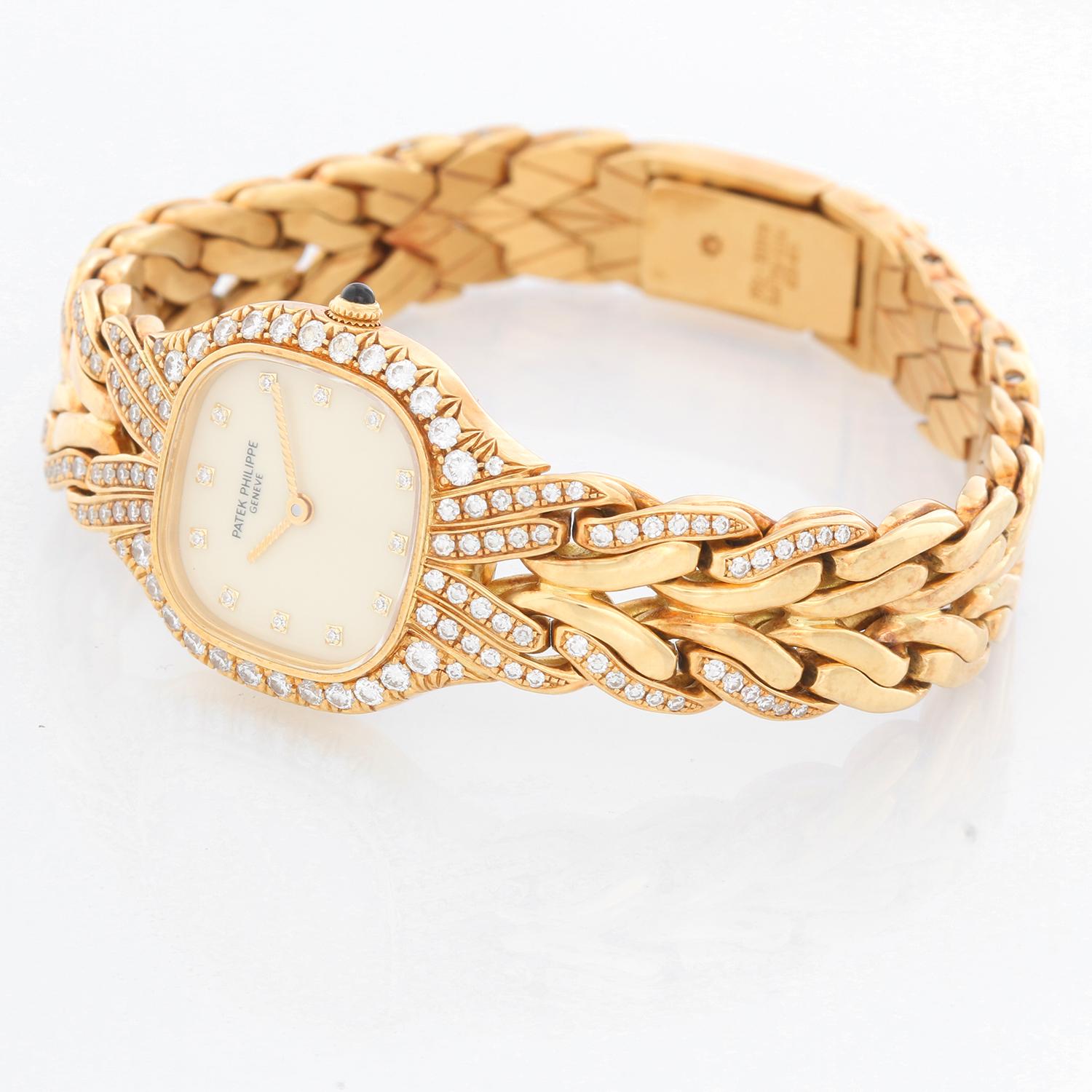 Patek Philippe & Co. La Flamme 18K Yellow Gold Watch Ref 4815 - Quartz. 18K Yellow Gold  with diamond bezel ( 22 x 27 mm ). Ivory dial with diamond hour markers. 18K Yellow Gold bracelet with partial diamond bracelet; 7 inch wrist. Pre-owned with