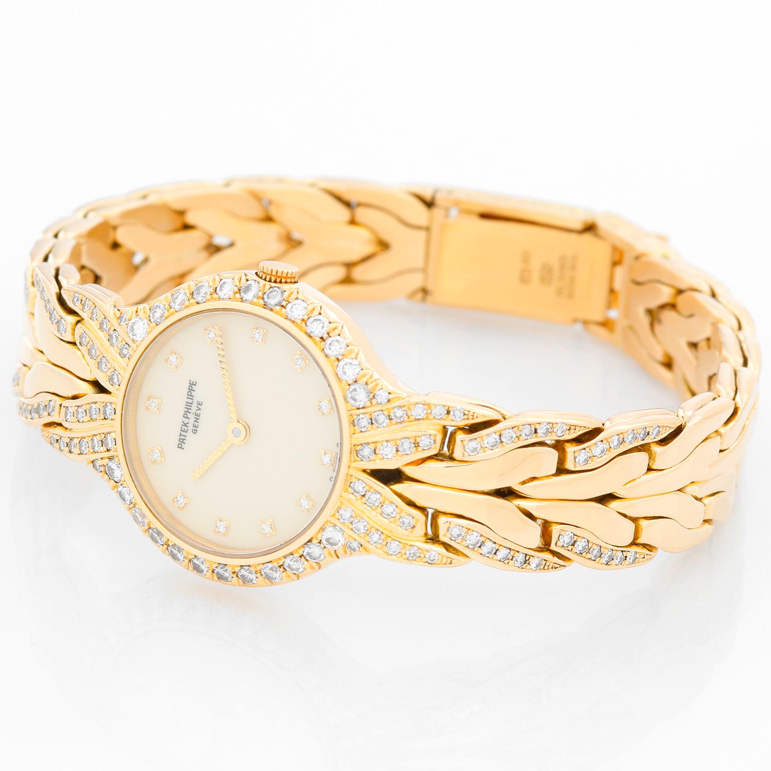 Patek Philippe & Co. La Flamme 18K Yellow Gold Watch Ref 4816 - Quartz. 18K Yellow Gold  with diamond bezel ( 24mm ). Ivory dial with diamond hour markers. 18K Yellow Gold bracelet with partial diamond bracelet; will fit a 6 1/2 inch wrist .