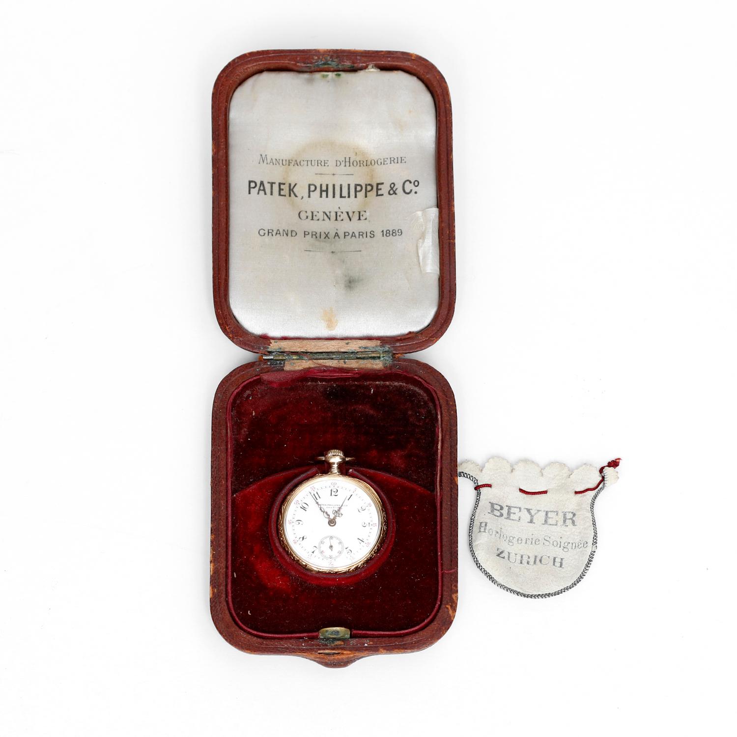 Patek Philippe & Co. Lady's Pocket Watch - Manual movement; 15 jewels. 18k Yellow gold ( 32 mm ) with gold cuvette, swirl leaf and scallops, back with ornate overlay monogram. Enamel dial with radial arabic numerals and red five minute, gold Louis