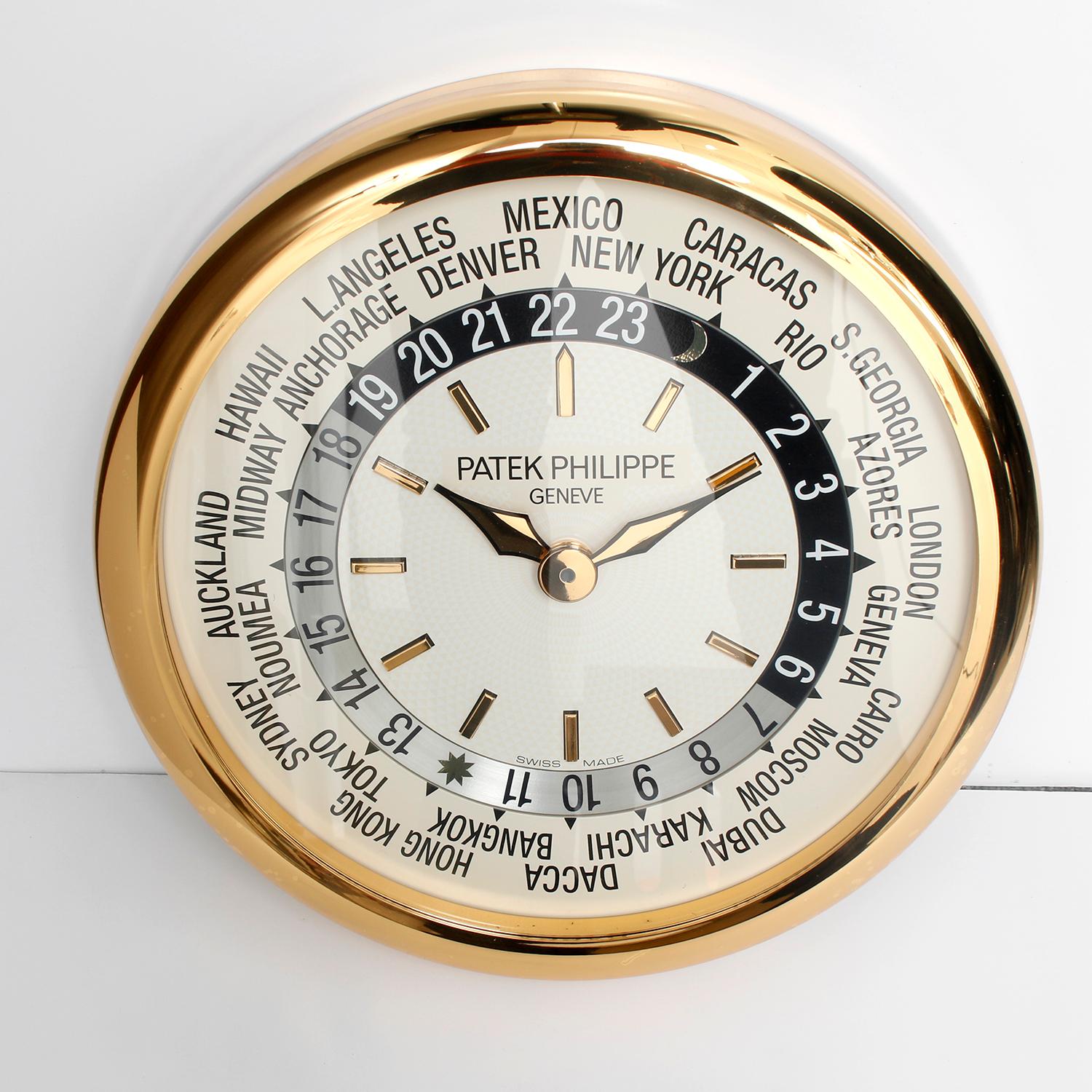 Patek Philippe & Co. World Time - Hours of The World Clock - Quartz. 15.7 inches in diameter. Silver dial with gold markers and silver and black 24-hour time zone dial. Original and rare.
