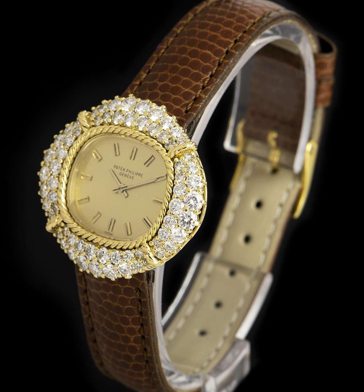 An 18k Yellow Gold Cocktail Ladies Wristwatch, velvet-finished champagne gilded dial with applied hour markers, a fixed 18k yellow gold bezel set with 64 round brilliant cut diamonds (~3.04ct), a brown leather strap with a gold plated pin buckle