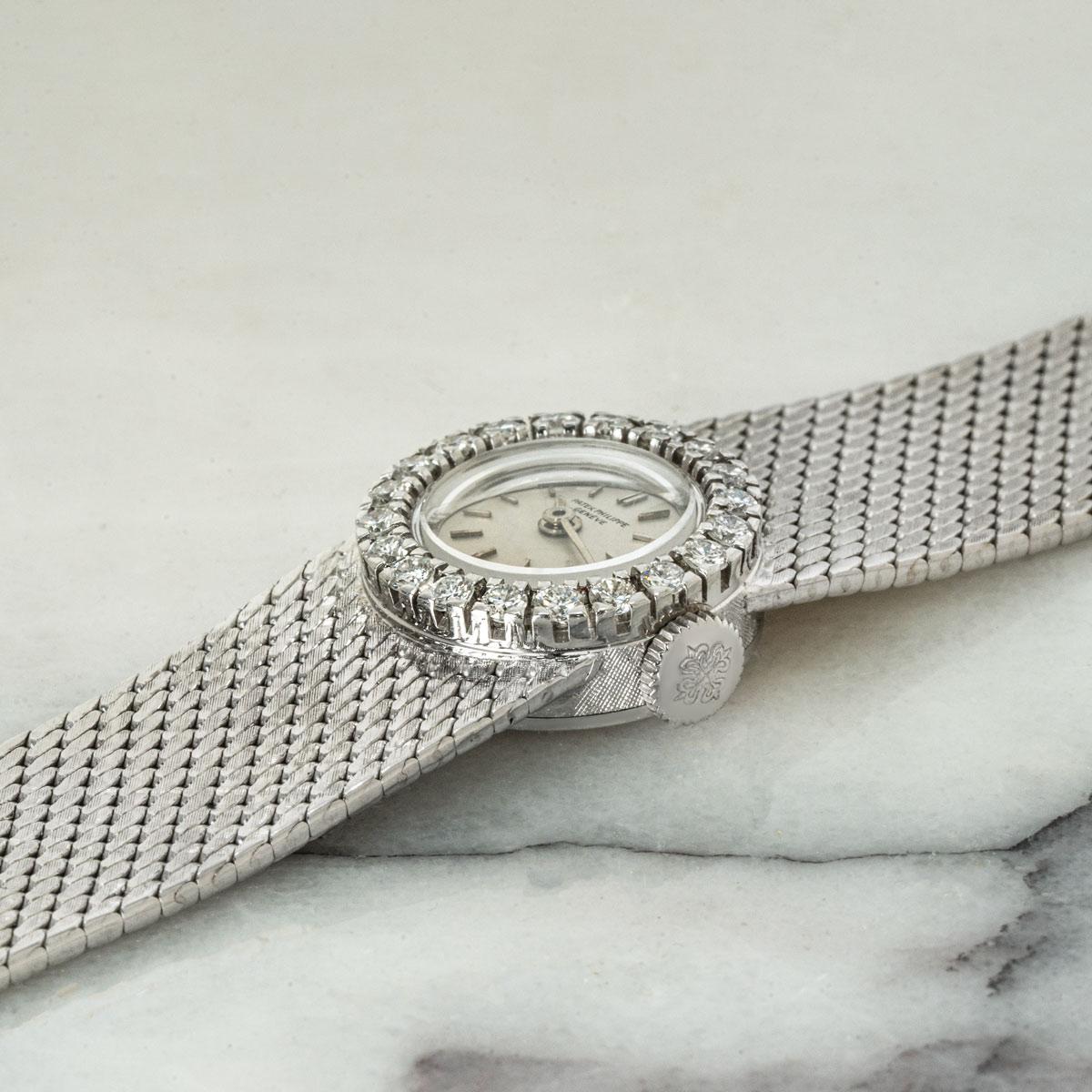 A white gold vintage Cocktail watch, by Patek Philippe. Featuring a silver dial and white gold bezel, the bezel being set with 20 round brilliant diamonds, ~0.49ct.

Fitted with a sapphire crystal and manual wind movement. This piece is presented on