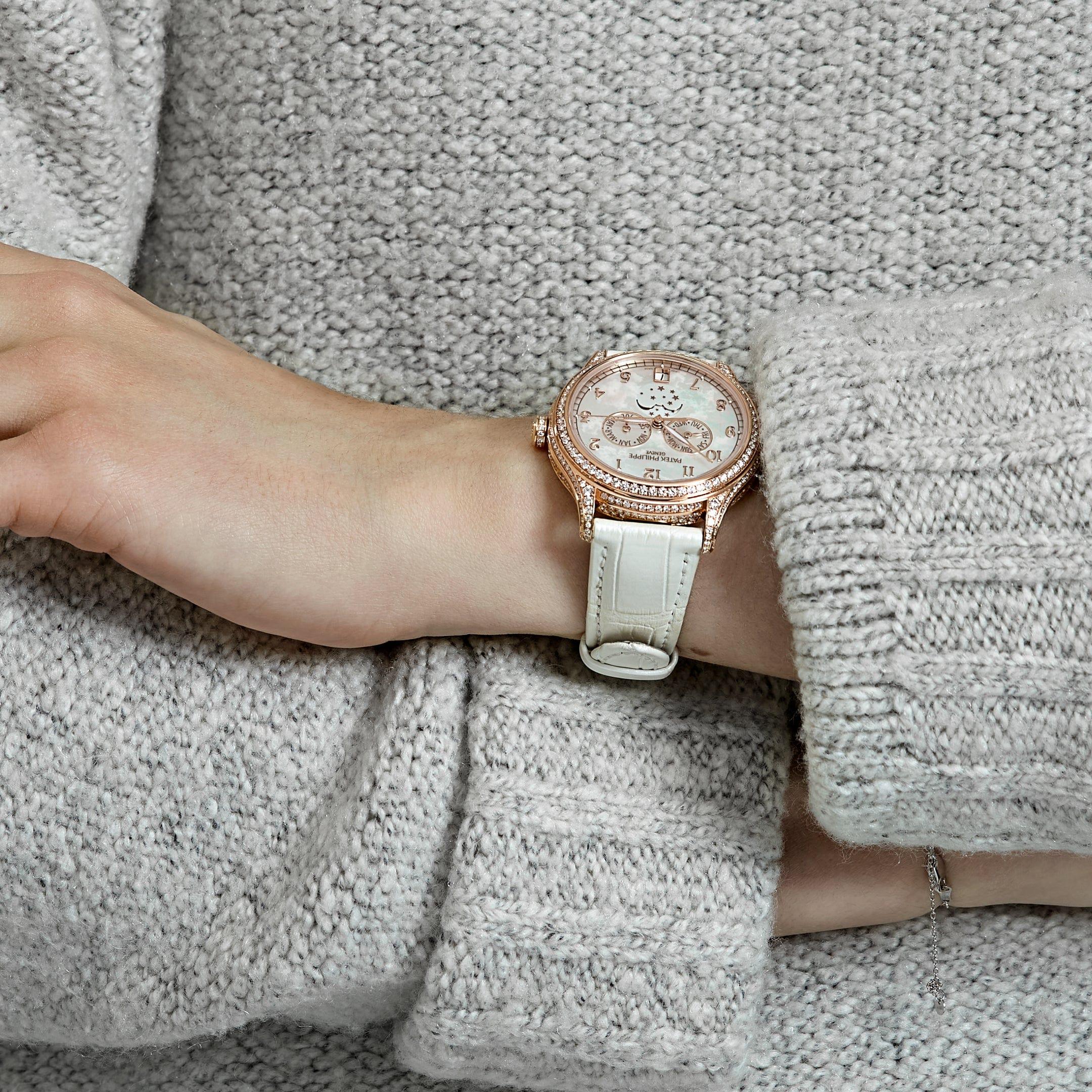 Jewels Aficionado offers the Patek Philippe Complications 4948R-001 is a masterful blend of horological complexity and timeless elegance. Crafted in 18k rose gold, this timepiece features a 38mm case adorned with a bezel set with 347 brilliant-cut
