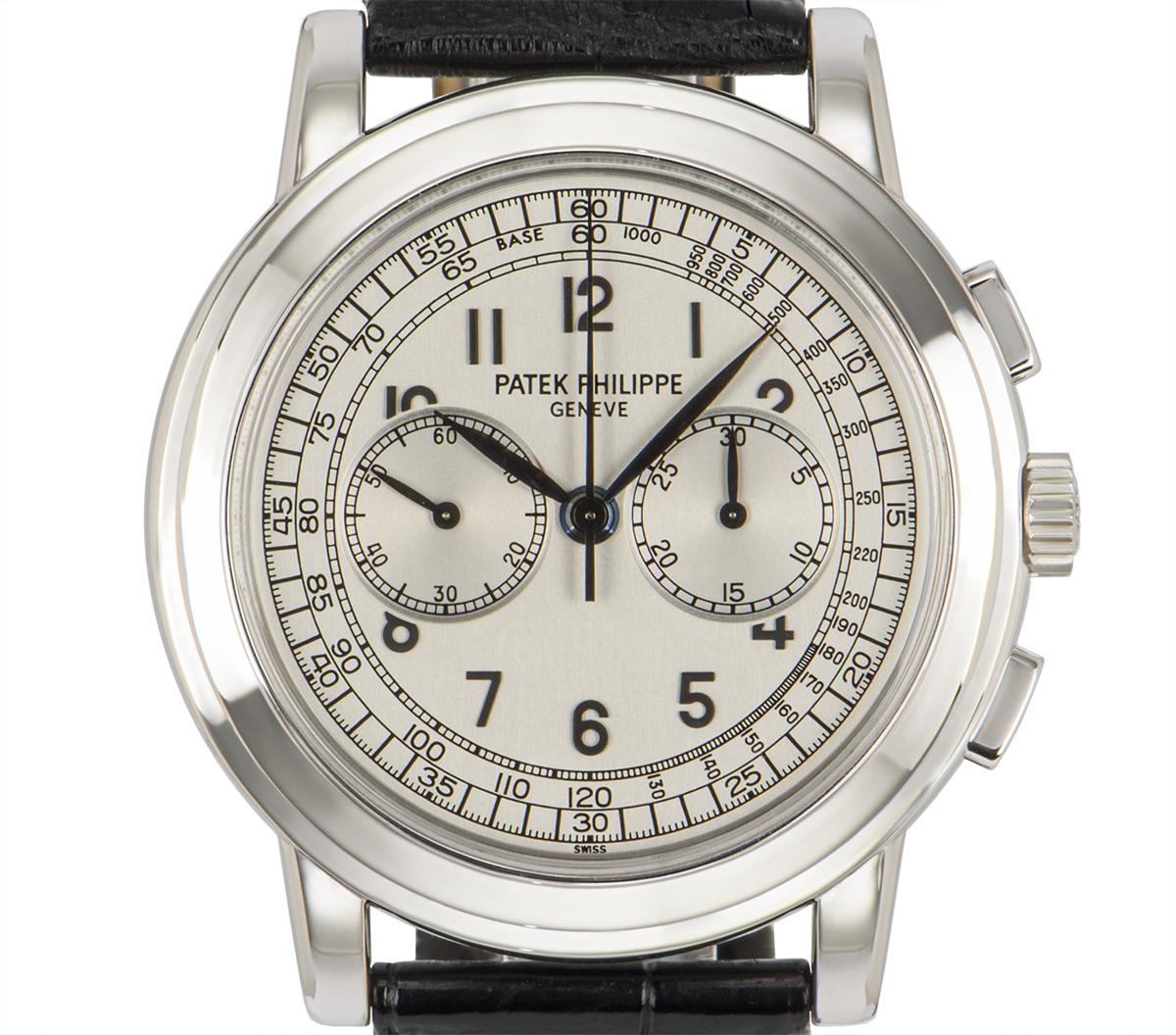 A 42 mm Complications Chronograph by Patek Philippe in white gold, featuring a silver dial. The dial features a 30 minute counter, a small seconds display and tachymetre. An original black leather strap comes with an original white gold deployant