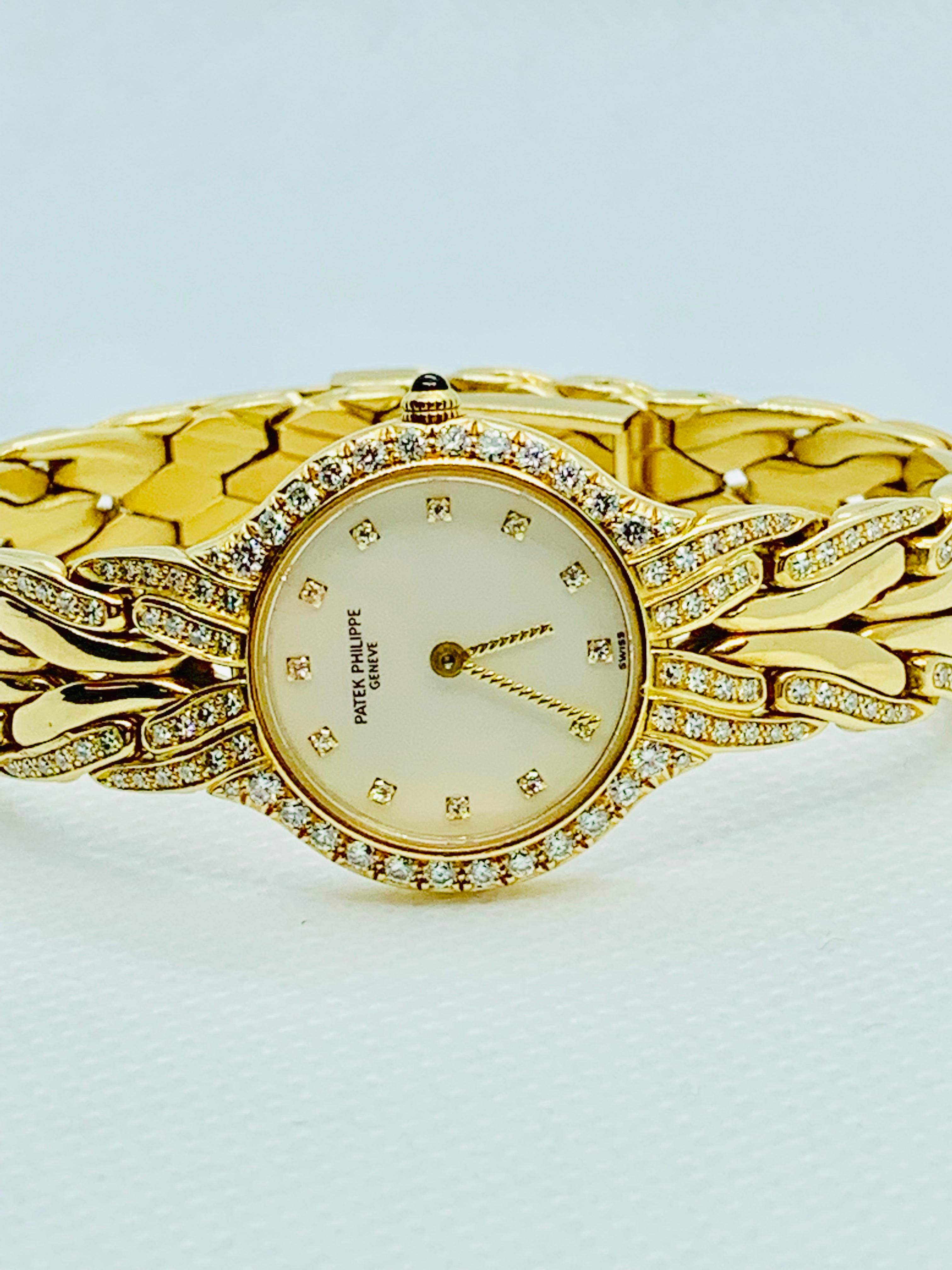 Gorgeous Patek Philippe la Flamme 21mm ladies Quartz watch! This piece is in 18K yellow Gold and features a mother of pearl dial and diamond bezel, as well as diamonds in the band and number markers. The watch has a total of 144 diamonds that are