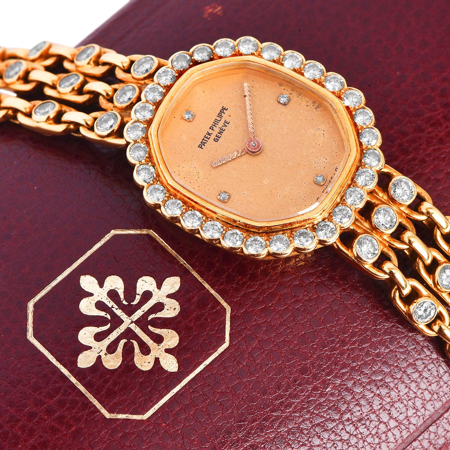 This exquisite all-original Patek Philippe diamond lady's watch is crafted in 18K yellow gold. The case presents an attractive gold diamond dial and bezel. and its bracelet is embraced by 30 round Brilliant cut diamonds. All diamonds are original