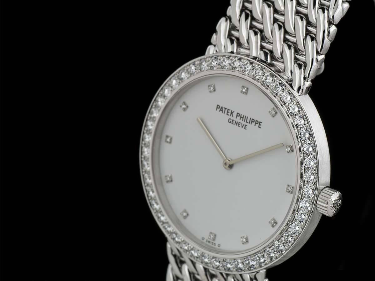 An 18k White Gold Calatrava Wristwatch 5006/17, white dial with 12 diamond dots, an 18k white gold fixed bezel with approximately 46 round brilliant cut diamonds, an original 18k white gold integrated bracelet with an original 18k white gold
