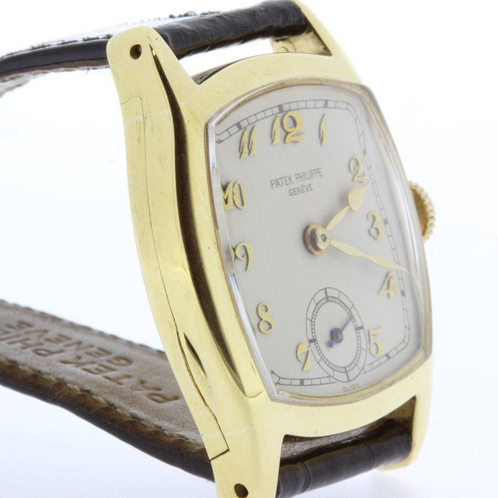 This Rare Early Vintage Patek Philippe Watch was made in 1927.  It measures 37 x 30mm, and is made of 18 karat yellow gold, with a hinged back case, 12