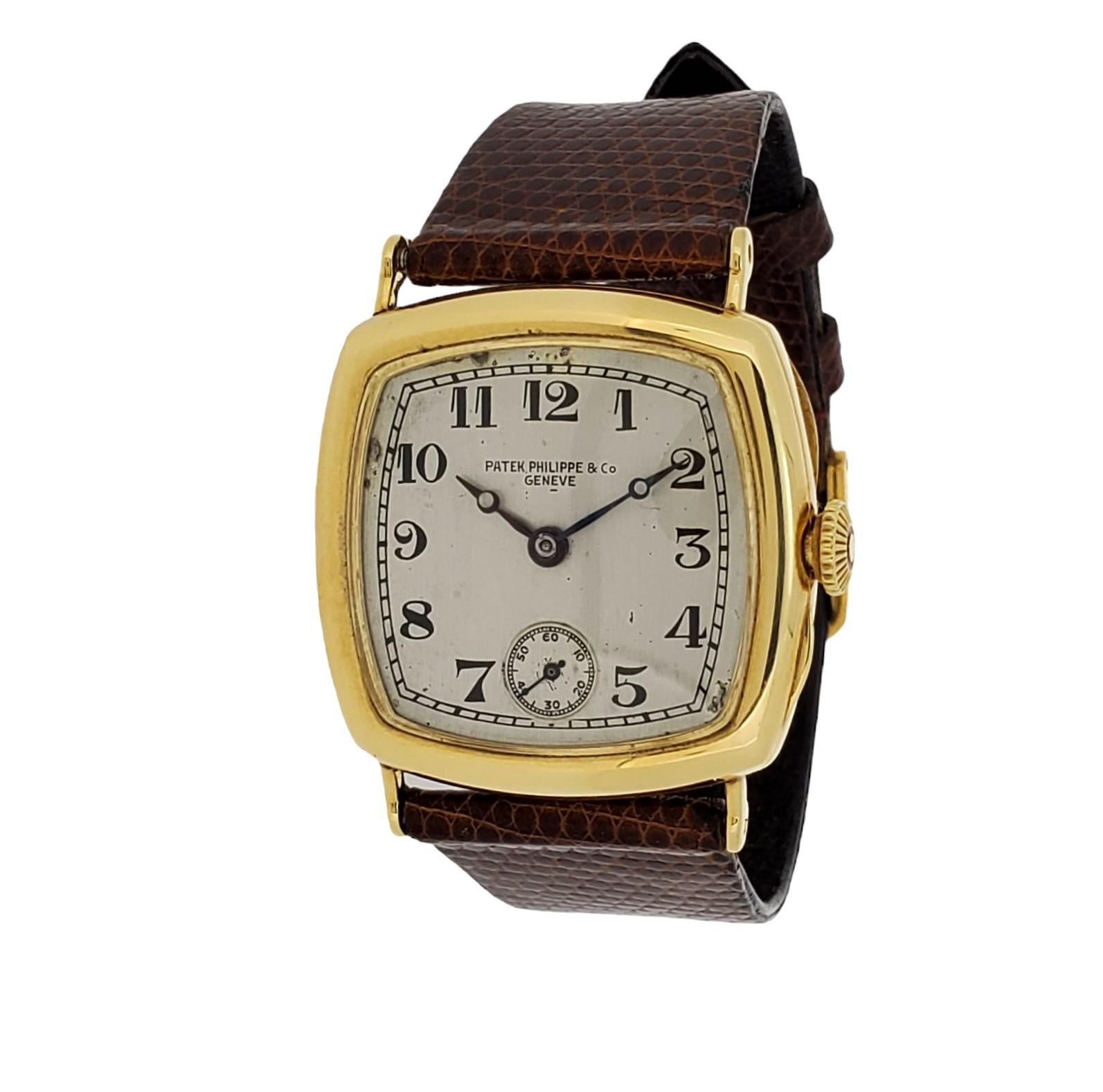 Patek Philippe Early Art Deco Cushion shape watch Circa 1927-1928,  The watch is made in 18K yellow gold and measuring 31 x31 mm.  The watch is fitted with a 10
