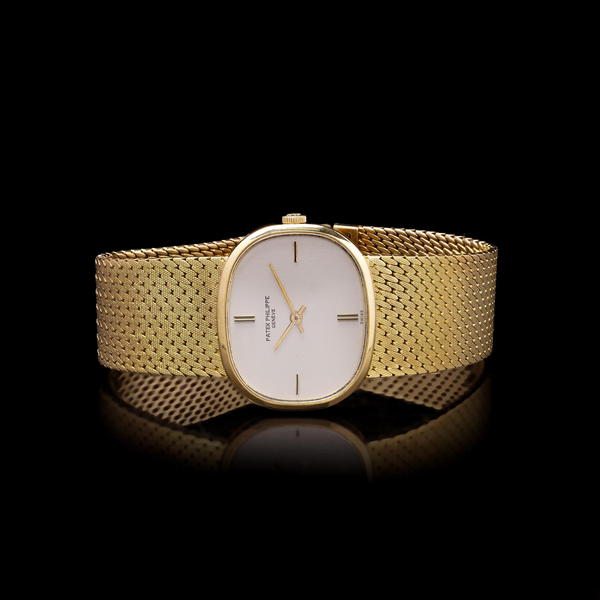 Vintage 1960s–1970s Patek Philippe 18kt Yellow Gold Manual Wind Wristwatch.

Crafted in solid 18kt yellow gold, the watch features a distinctive oval-shaped case with minimalist hour markers and baton hands, all framed by a finely woven