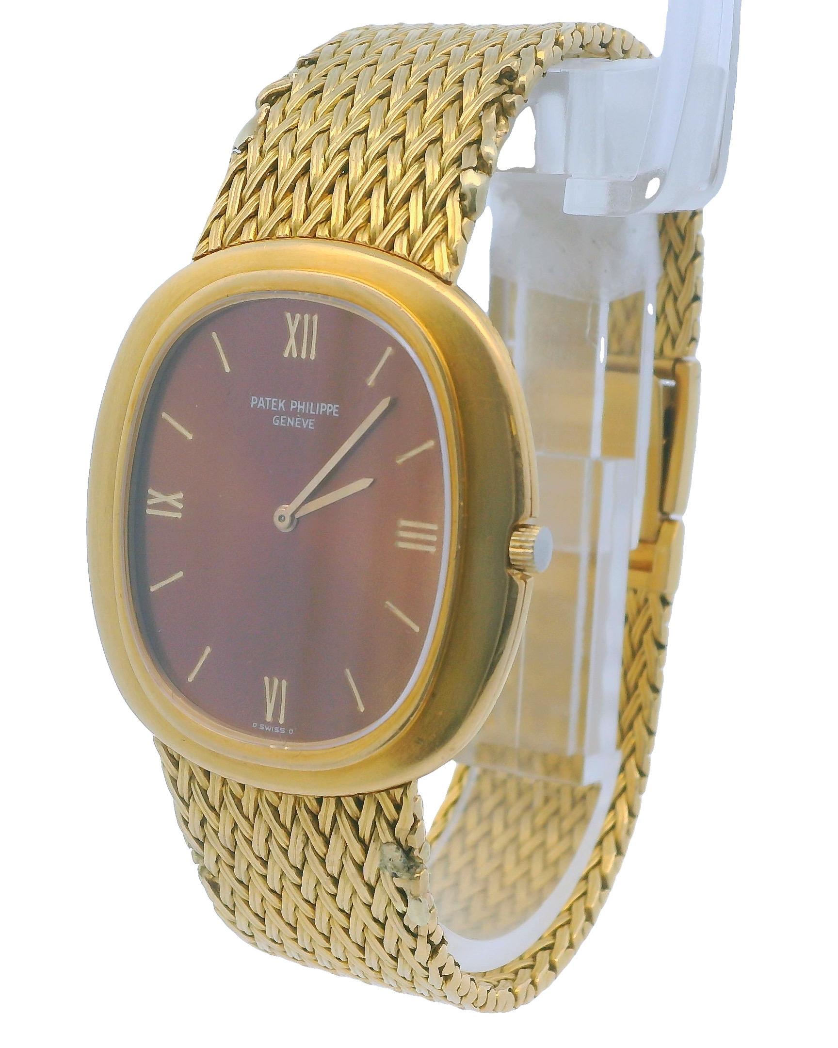 Patek Philippe Ellipse 3589/1 Watch. This elegant timepiece features a 33mm 18K yellow gold case and an 18K yellow gold bezel. The bronze dial is complemented by gold hands and index hour markers. The watch includes an 18K yellow gold mesh bracelet