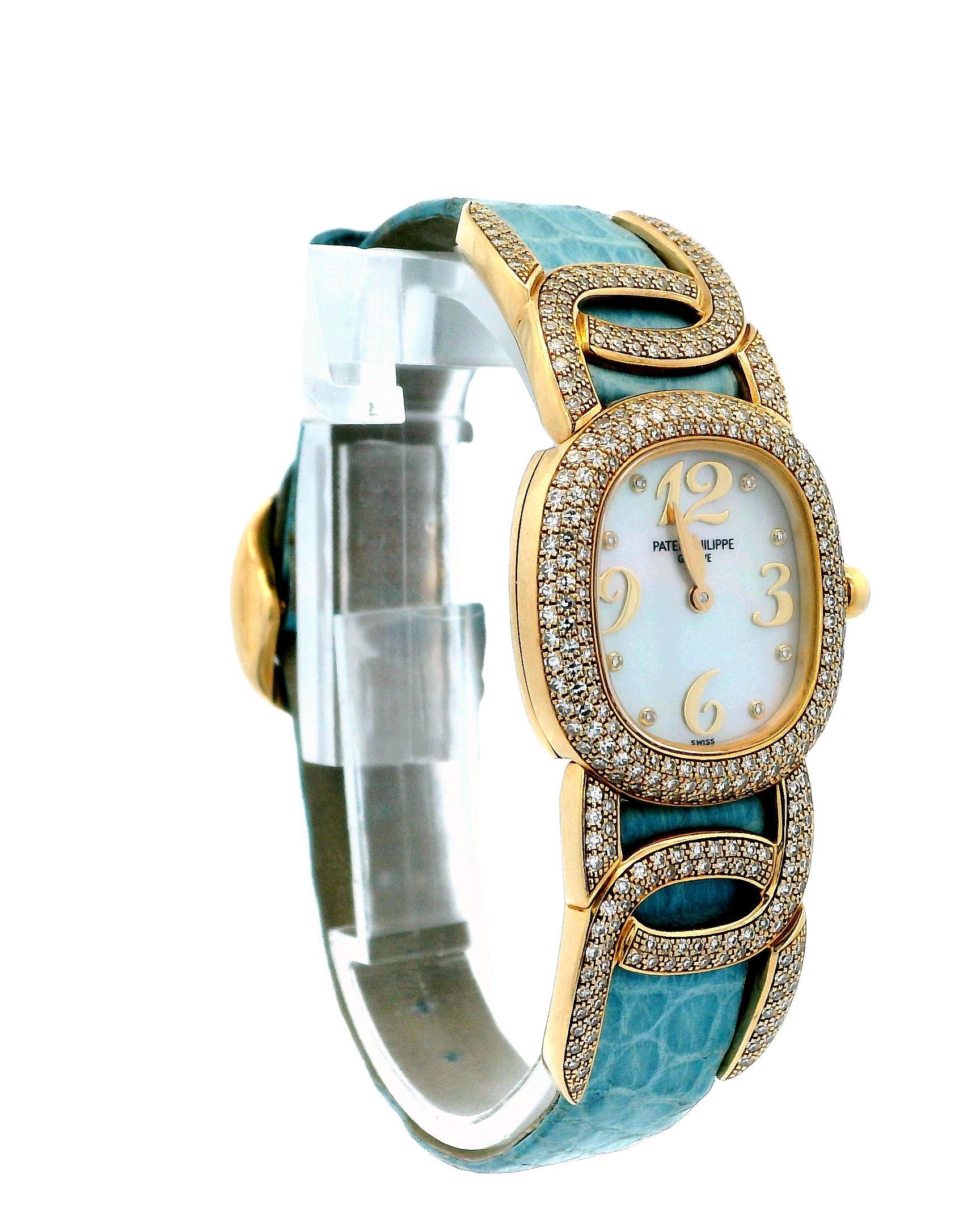 Patek Philippe Golden Ellipse 4832 Ladies Watch. This watch features a 23mm 18K yellow gold case adorned with factory-set diamonds. It has a mother-of-pearl dial with gold hands, complemented by factory diamond and Arabic numeral hour markers. The