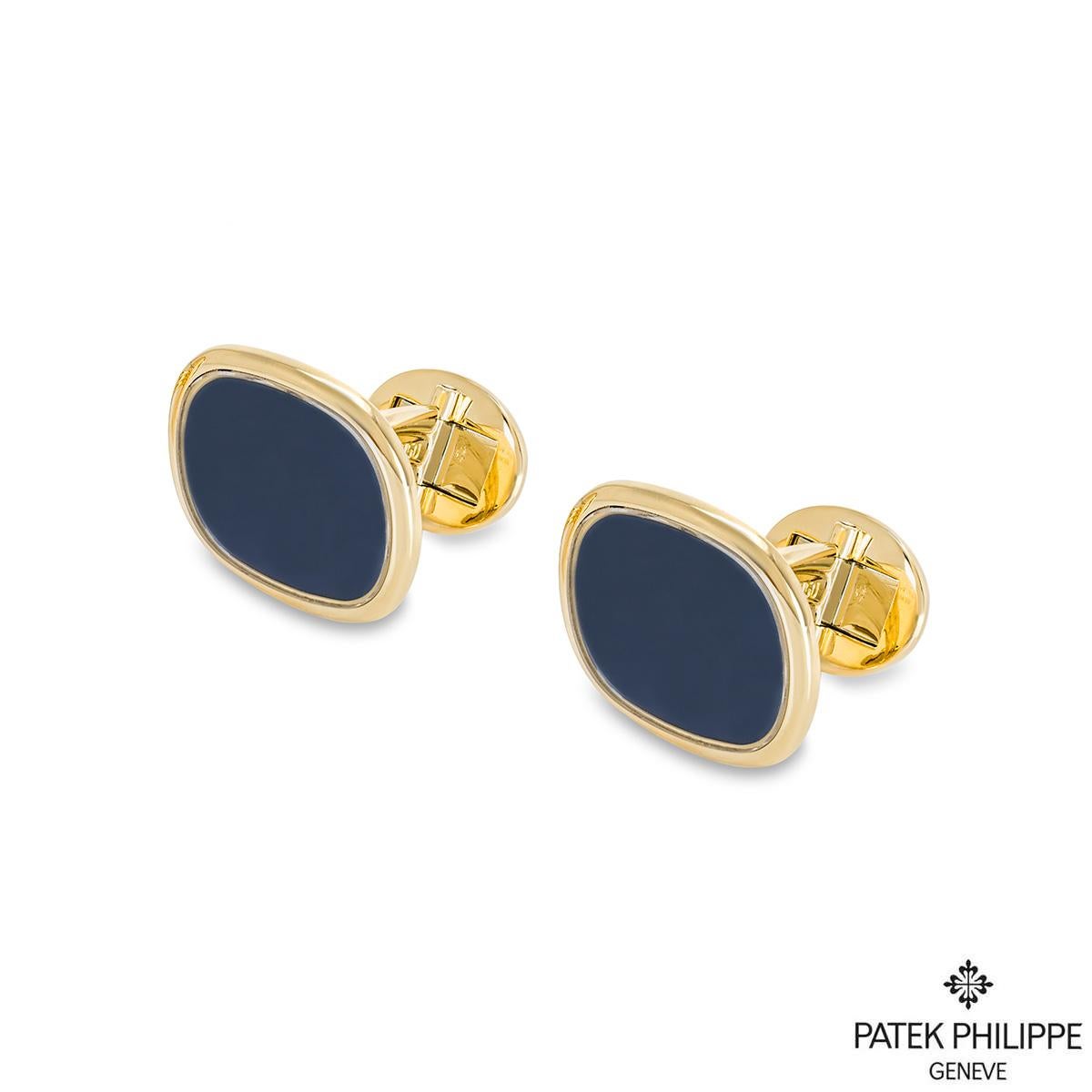 A pair of 18k yellow gold large Ellipse cufflinks by Patek Philippe. Each cufflink has a blue centre surrounded by yellow gold. Measuring 19mm in height and 22mm in width. The cufflinks have T-bar fittings and have a gross weight of 25.9 grams.

The