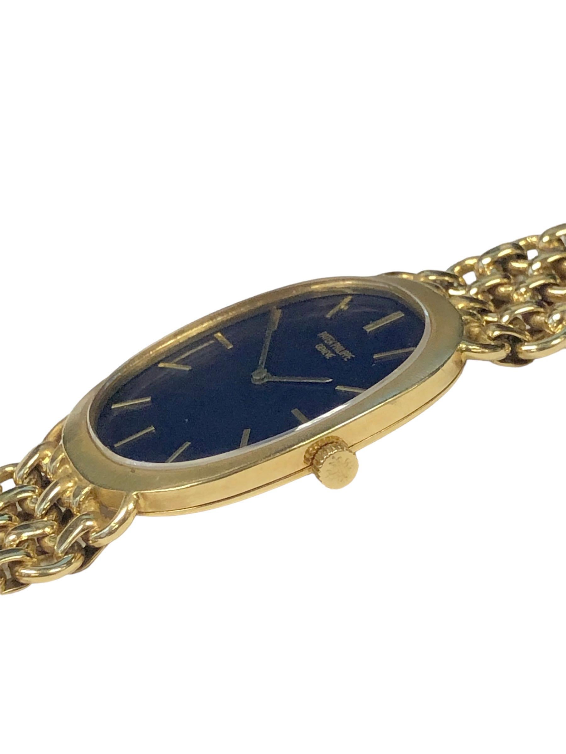 Circa 1980s Patek Philippe Ellipse Reference 3577 / 1  Gents Wrist Watch,  33 x 26 M.M. 2 Piece 18k Yellow Gold case. 18 Jewel, Caliber 175 Mechanical, Manual Wind Movement, Blue Dial with Raised Gold Markers. 3/4 inch wide integrated link bracelet,