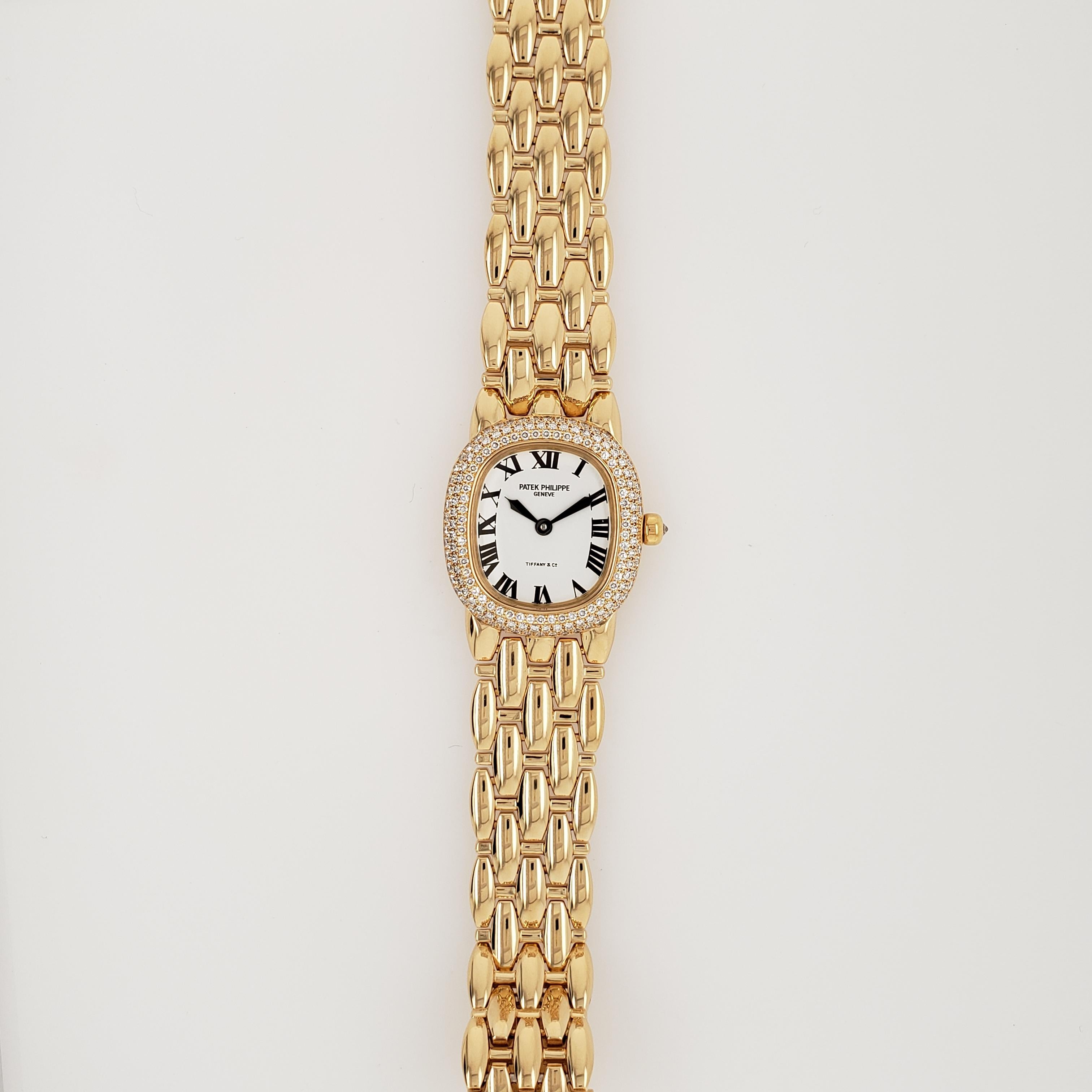 18kt Yellow Gold. Patek Philippe Ellipse Ref. 4831 watch. The watch features a white roman dial with a diamond bezel, a diamond crown, and a gold bracelet. Case diameter 25.5mm x 23mm (h x w). This watch has been fully overhauled & comes with a 1