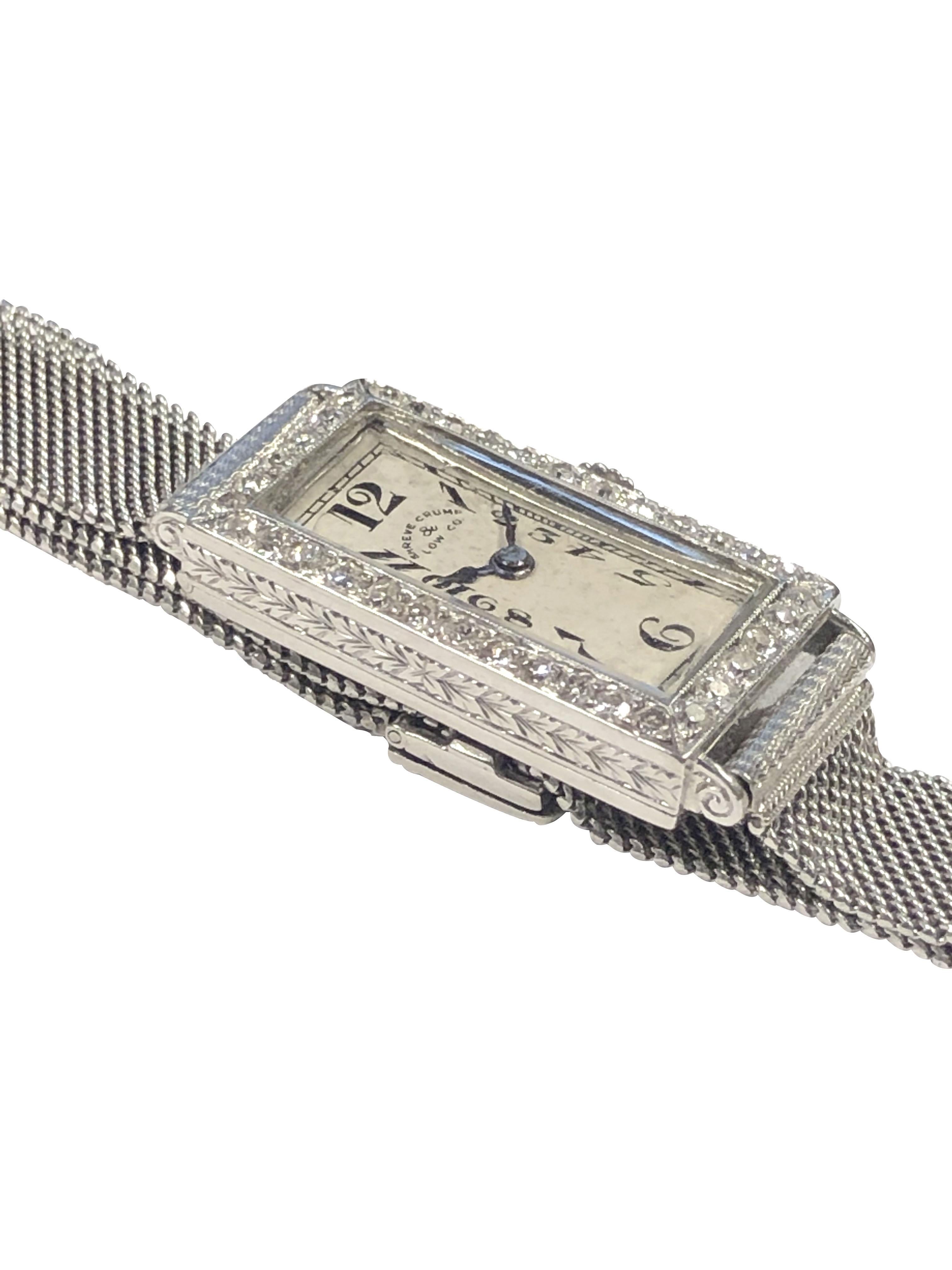 Circa 1920s Patek Philippe Ladies Bracelet Wrist Watch retailed by Shreve Crump & Low, 24 X 13 M.M. Platinum case set with Old cut Diamonds. Hand Engraved design work on the case sides and case back. 18 Jewel Patek Philippe Mechanical, Manual wind