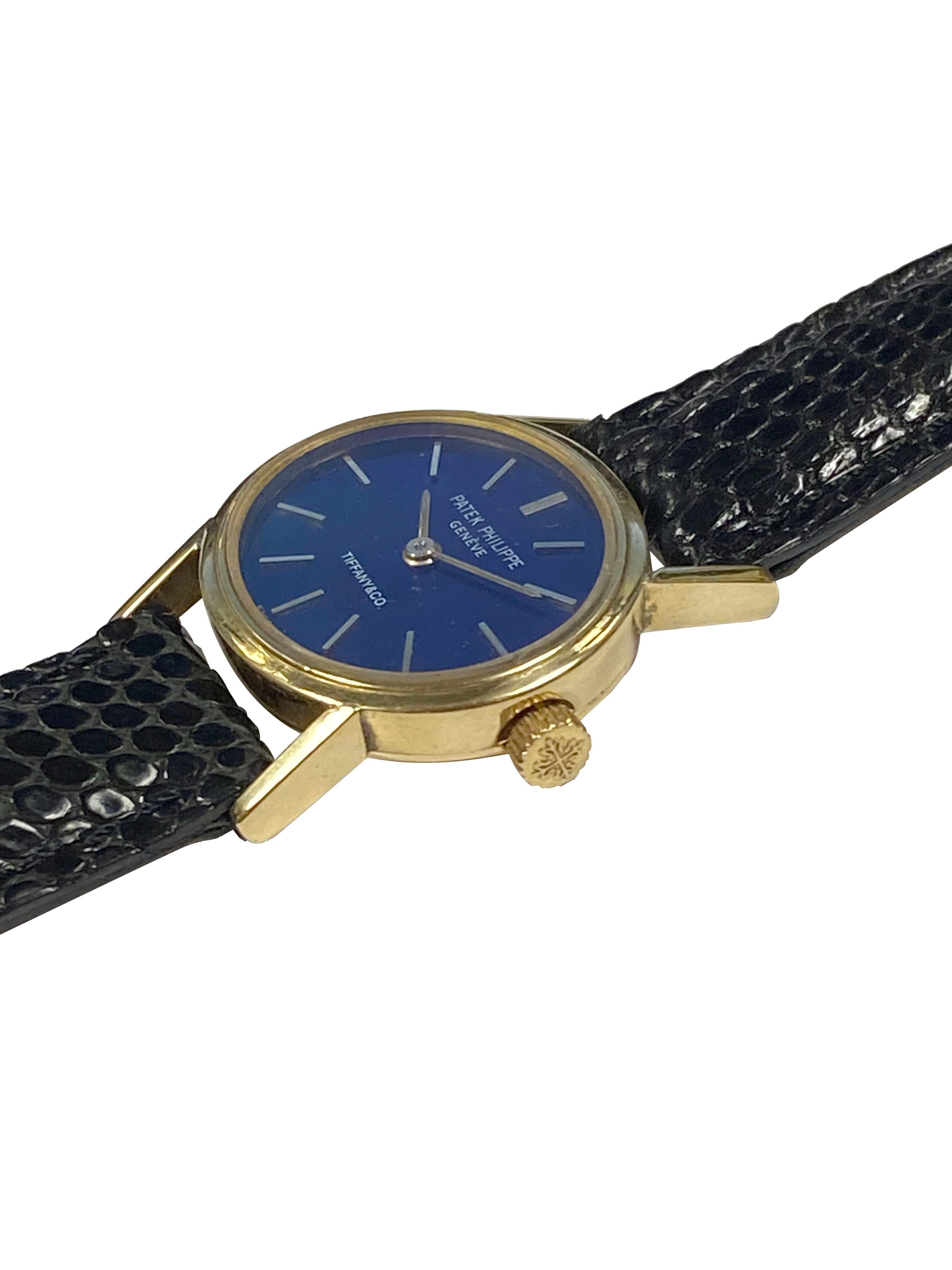 Circa 1980 Ladies Patek Philippe Reference 3349  for Tiffany & Company, 22 x 19 M.M. 18k Yellow Gold 2 piece case, 20 Jewel, mechanical, manual wind nickle lever movement. Patek Philippe logo crown. Blue Gloss dial with raised Gold markers. New