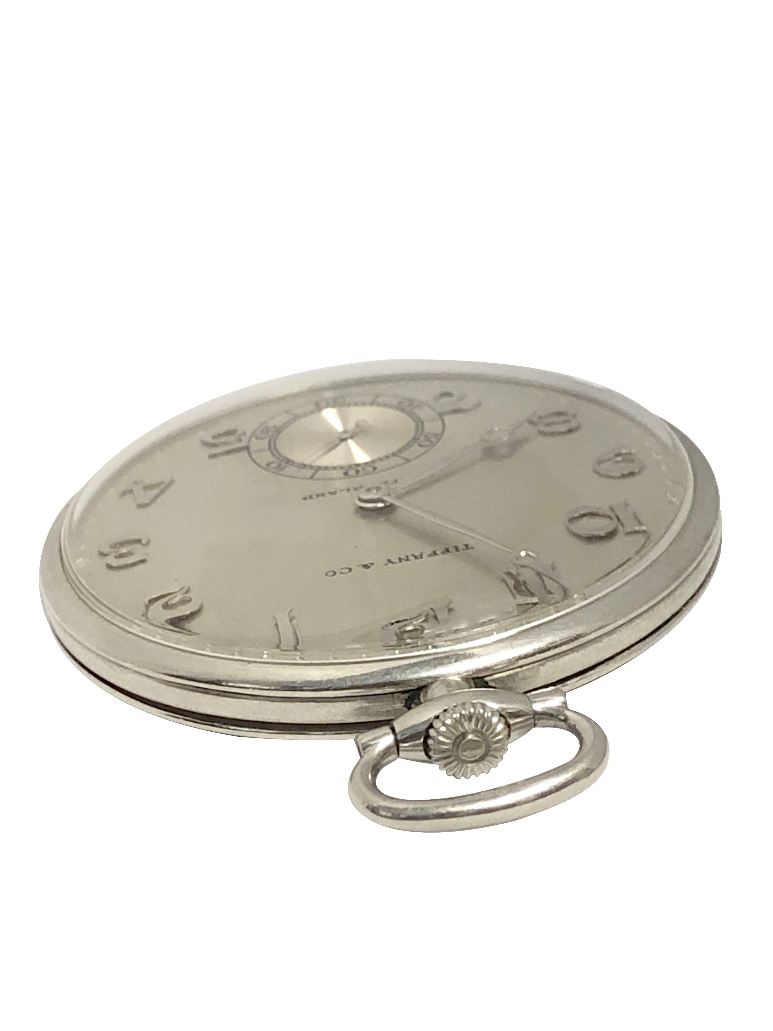 Circa 1930 Patek Philippe Pocket Watch  Retailed by Tiffany & company,  43 M.M. Platinum 3 Piece case, 18 Jewel Manual wind Nickle lever movement. Silver Satin dial with raised Gold Arabic Markers, sub seconds hand, Diamond shape Plaque for