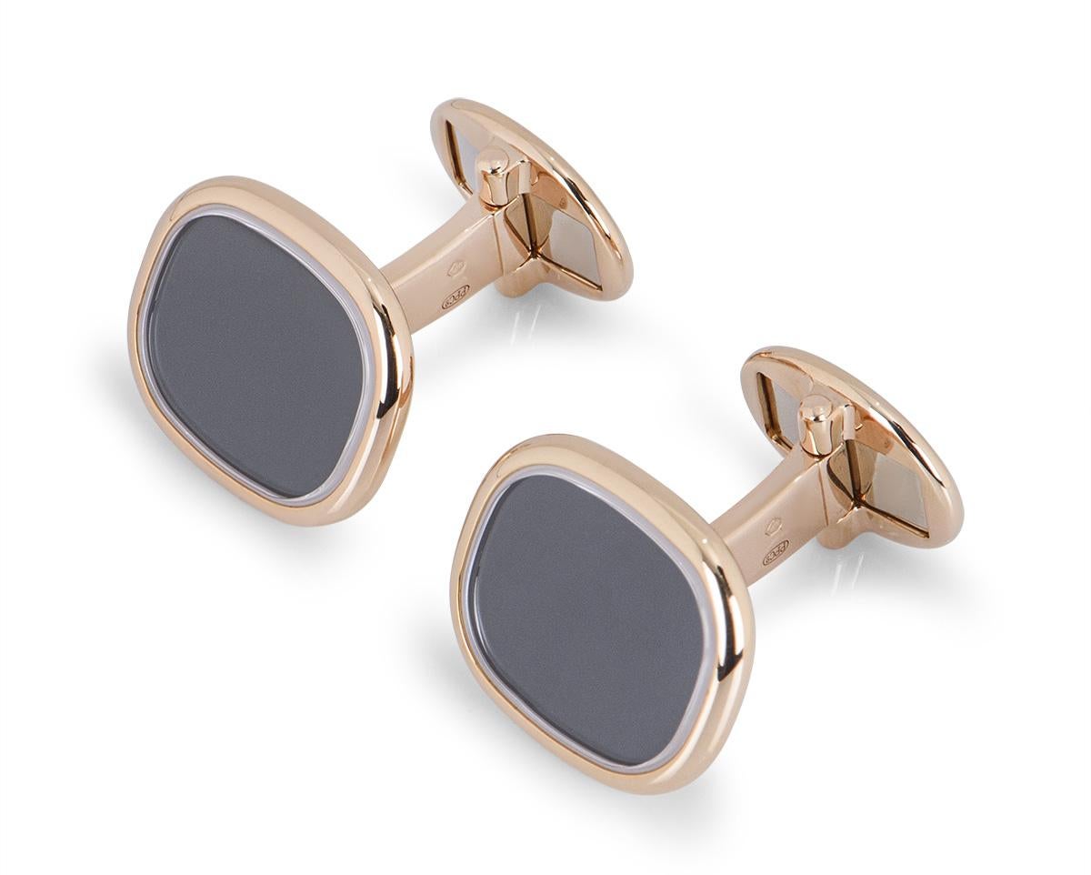 A pair of rose gold Golden Ellipse cufflinks from Patek Philippe. Each one has an ebony black sunburst centre surrounded by rose gold and measures 16mm in width and 14mm in height. Both cufflinks have t-bar fittings and weigh a total of 16