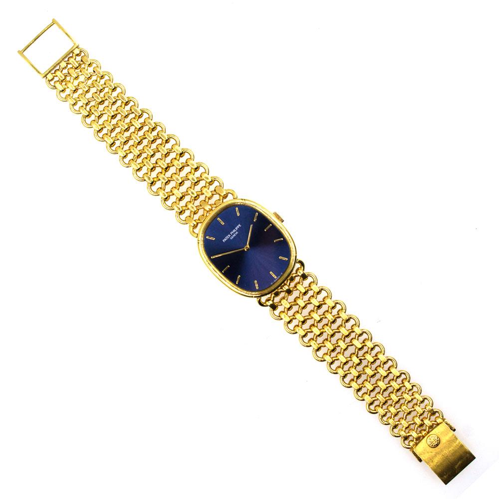 18K yellow gold 28mm x 32mm Patek Philippe 3848/1  Golden Ellipse watch featuring a manual wind movement, smooth bezel, blue dial, 18 karat link bracelet and hinged clasp closure. The watch measures 7.5 inches in length and is signed Patek Philippe