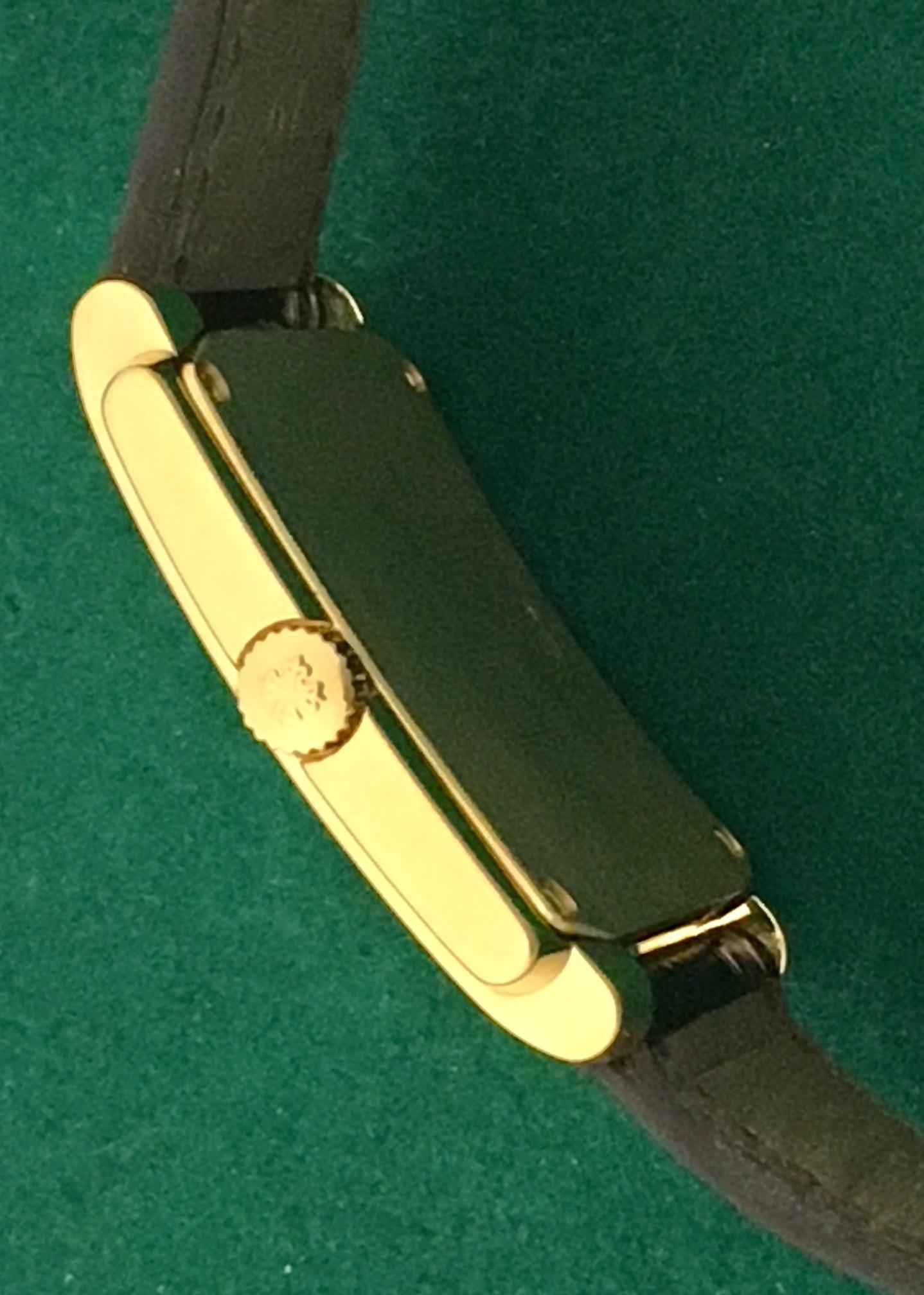  Patek Philippe Gondola Men's Manual Winding wrist watch. Model 5024 J. Certified Pre Owned and ready to ship! Patek Philippe Cailber 215 Movement with 19 Jewels. White Dial with Black Arabic numerals,  18k Yellow Gold rectangular style case