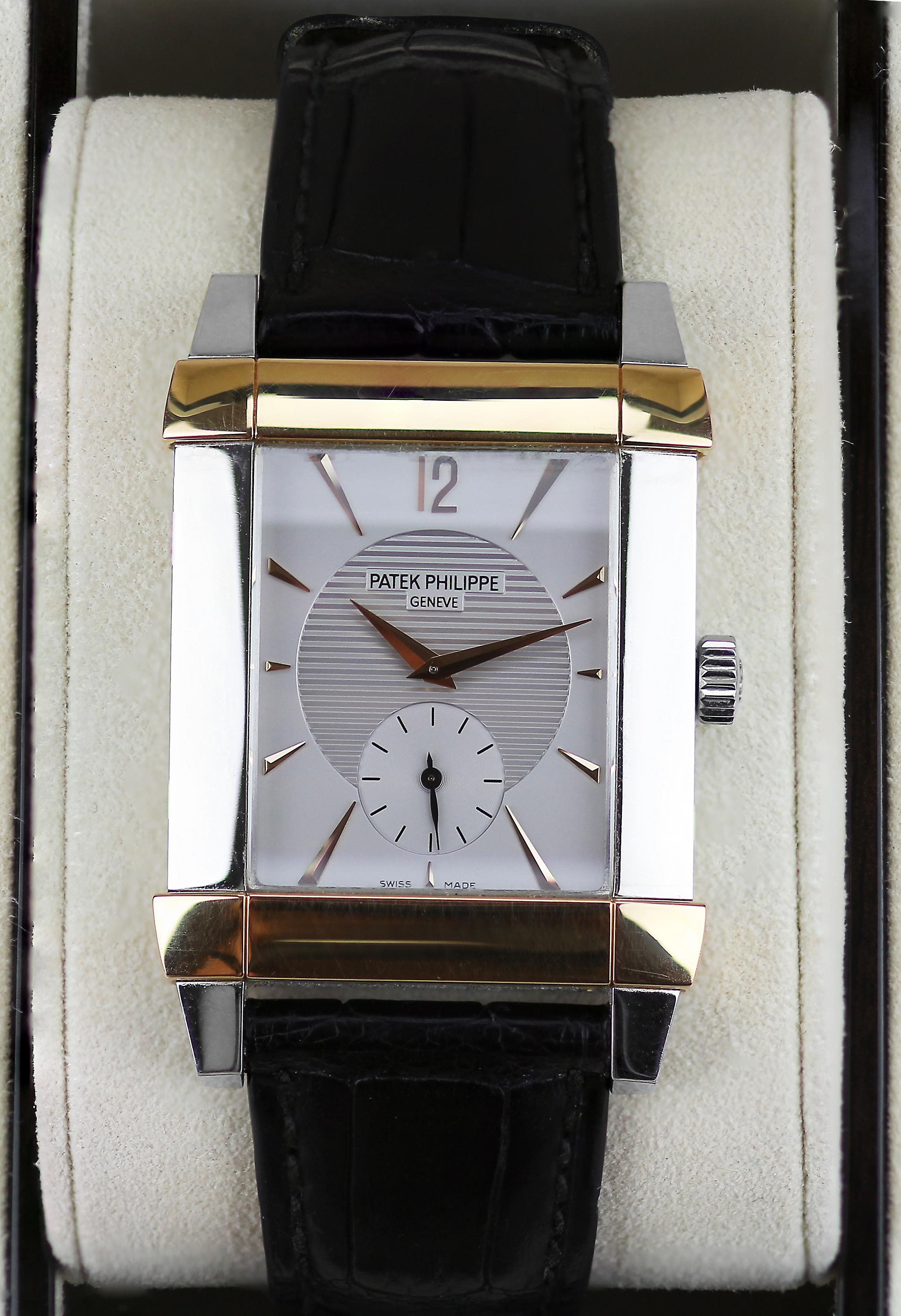 Platinum and rose gold case with a black leather strap include original box and papers. Fixed bezel. Silver dial with gold-toned hands and index hour markers. 
Dial Type: Analog. Small seconds sub-dial. Manual wind movement. Scratch resistant