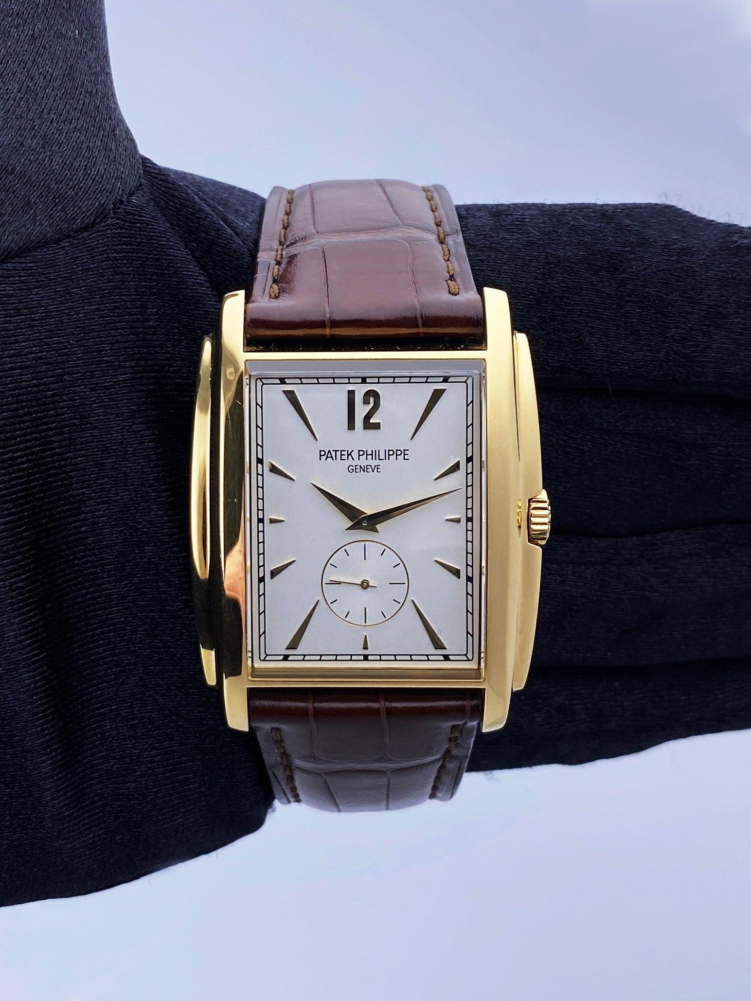 Patek Philippe Gondolo 5124J-001 Mens Watch. 33mm 18K yellow gold case. Silver dial with gold hands and Arabic numeral & index hour marker. Small second sub-dial display between 5 & 7 o'clock position. Brown leather strap with 18K