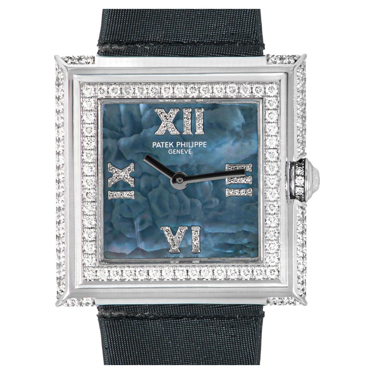 A stunning ladies 28mm Gondolo wristwatch in white gold by Patek Philippe. Featuring a captivating blue mother of pearl dial with diamond set roman numerals. Complimenting the dial is a fixed white gold bezel and case set with approximately 223