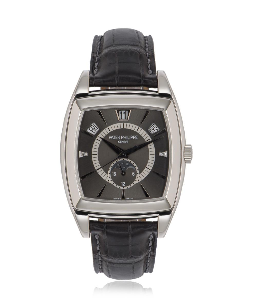 A platinum 38mm Gondolo Calendario by Patek Philippe. Features an anthracite grey dial with a typical annual calendar display (day, date and month). The dial also has a moon phase and 24 hour display at 6 o'clock and a single tapered baguette cut