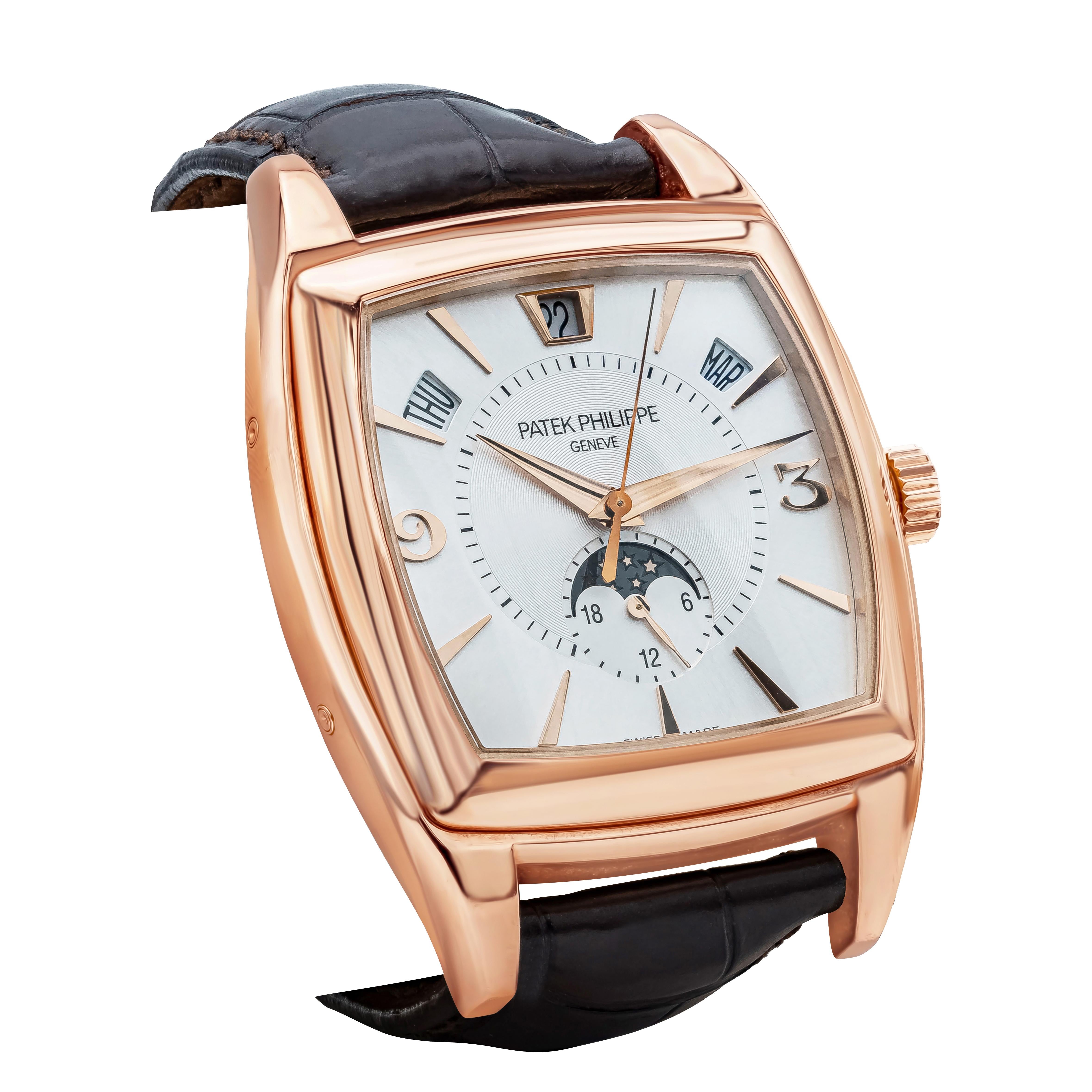Silvered Dial with Rose Gold Hands, Arabic Numerals and Index Hour Markers, Center Sweep Seconds Hand. 
18K Rose Gold Smooth Bezel, Day-Date-Month Indicators, 24 Hour Subdial with Moonphase, Sapphire Crystal. 
Highest Quality Brown Patek Philippe