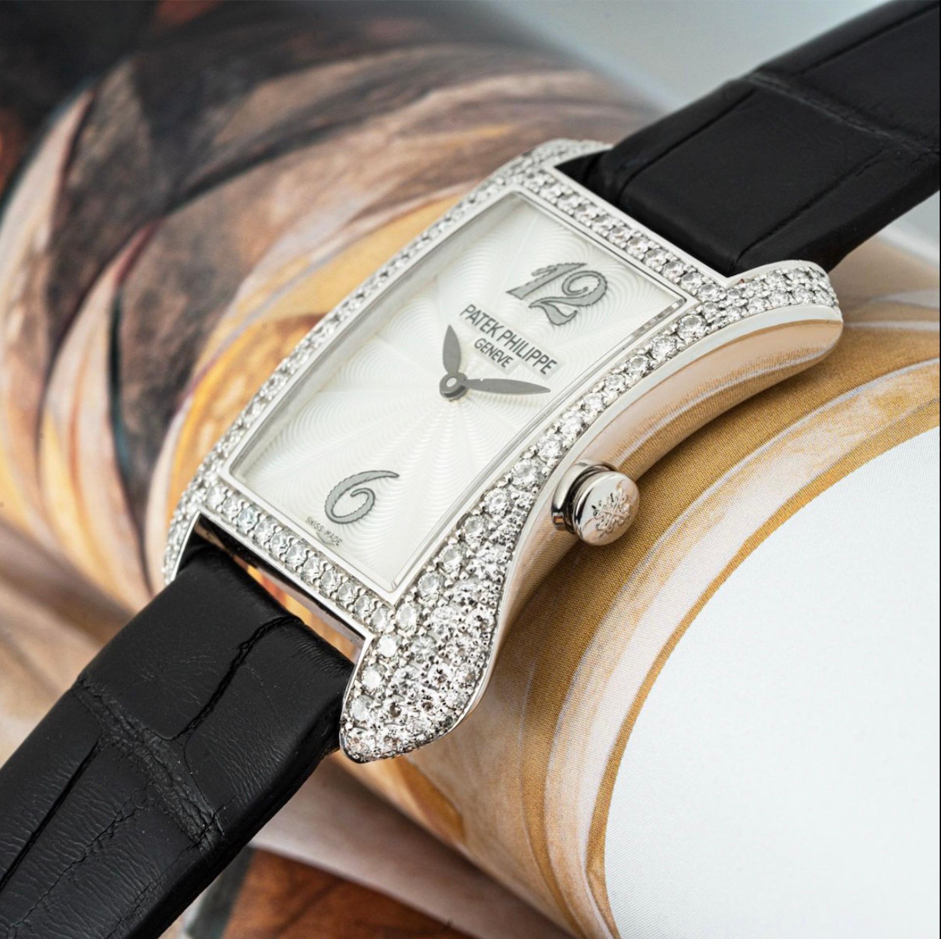 A ladies Patek Philippe Gondolo crafted in white gold. Featuring a distinctive guilloche mother of pearl dial with arabic numbers 12 and 6. Complementing the dial is a white gold case set with 130 round brilliant cut diamonds weighing 1.52ct.

The