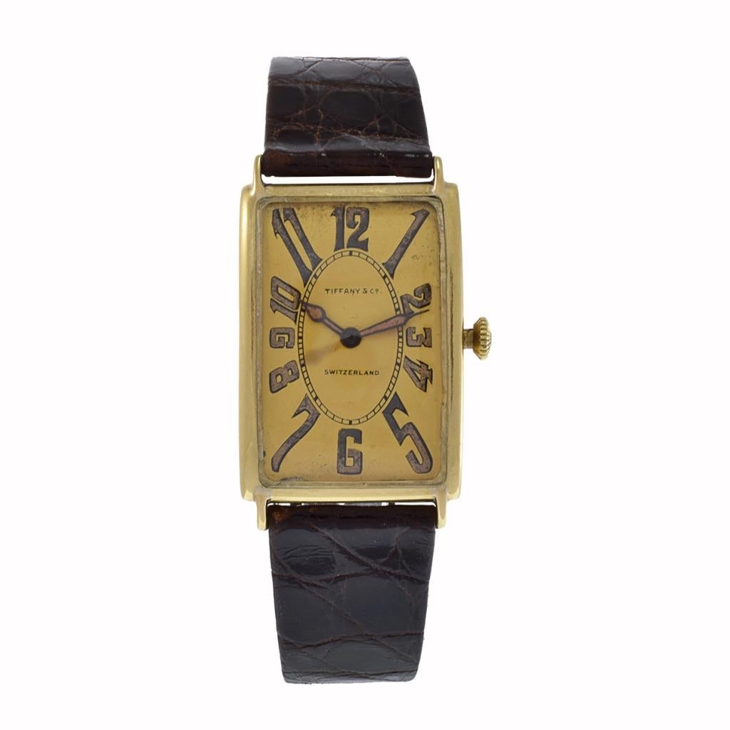 Delve into a legacy of craftsmanship with the Patek Philippe Gondolo Tiffany watch from 1911. This distinguished timepiece captivates with its large tank-style case, exquisitely forged from 18kt gold. Its gilt dial stands as a canvas for full Arabic