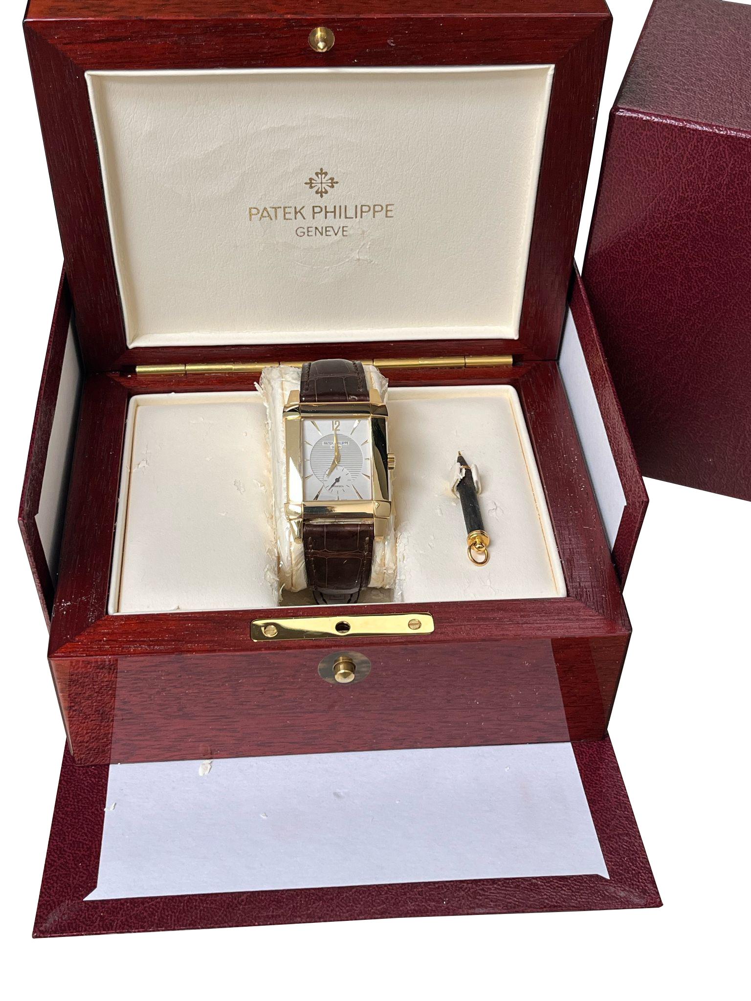 Patek Philippe Gondolo 5111J Mens Watch. 18K yellow gold case. Silver dial with Tiffany & Co. stamped. Gold hands and Arabic numeral & index hour marker. Small second sub-dial display between 5 & 7 o'clock and position. Brown leather strap with 18K
