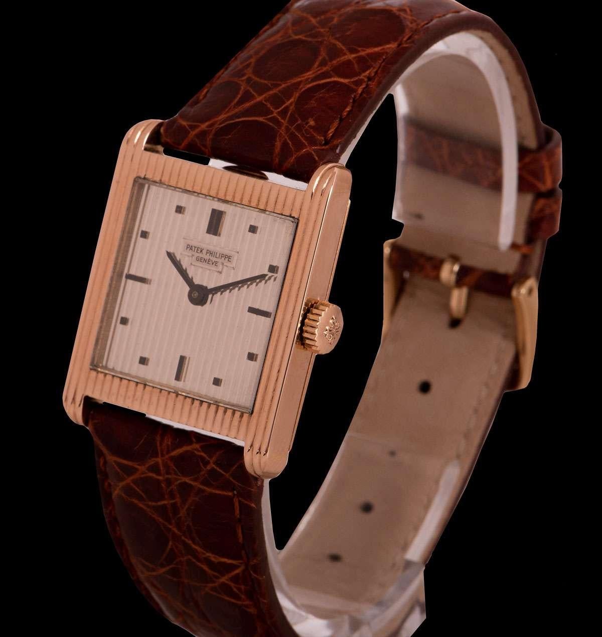 A 26mm 18k Rose Gold Gondolo Vintage Gents Wristwatch, silver guilloche dial with applied hour markers, a fixed 18k rose gold ribbed pattern bezel and case, a brown leather strap with a gold plated pin buckle (both not by Patek Philippe), mineral
