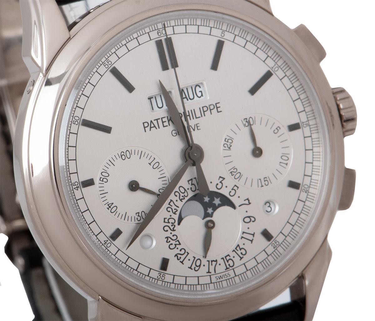 A 41 mm Grand Complications Perpetual Calendar Chronograph, in white gold by Patek Philippe. It's silver dial concealed with sapphire crystal features a 30 minute counter, moon phases with the date, day/night display and small seconds. The day and