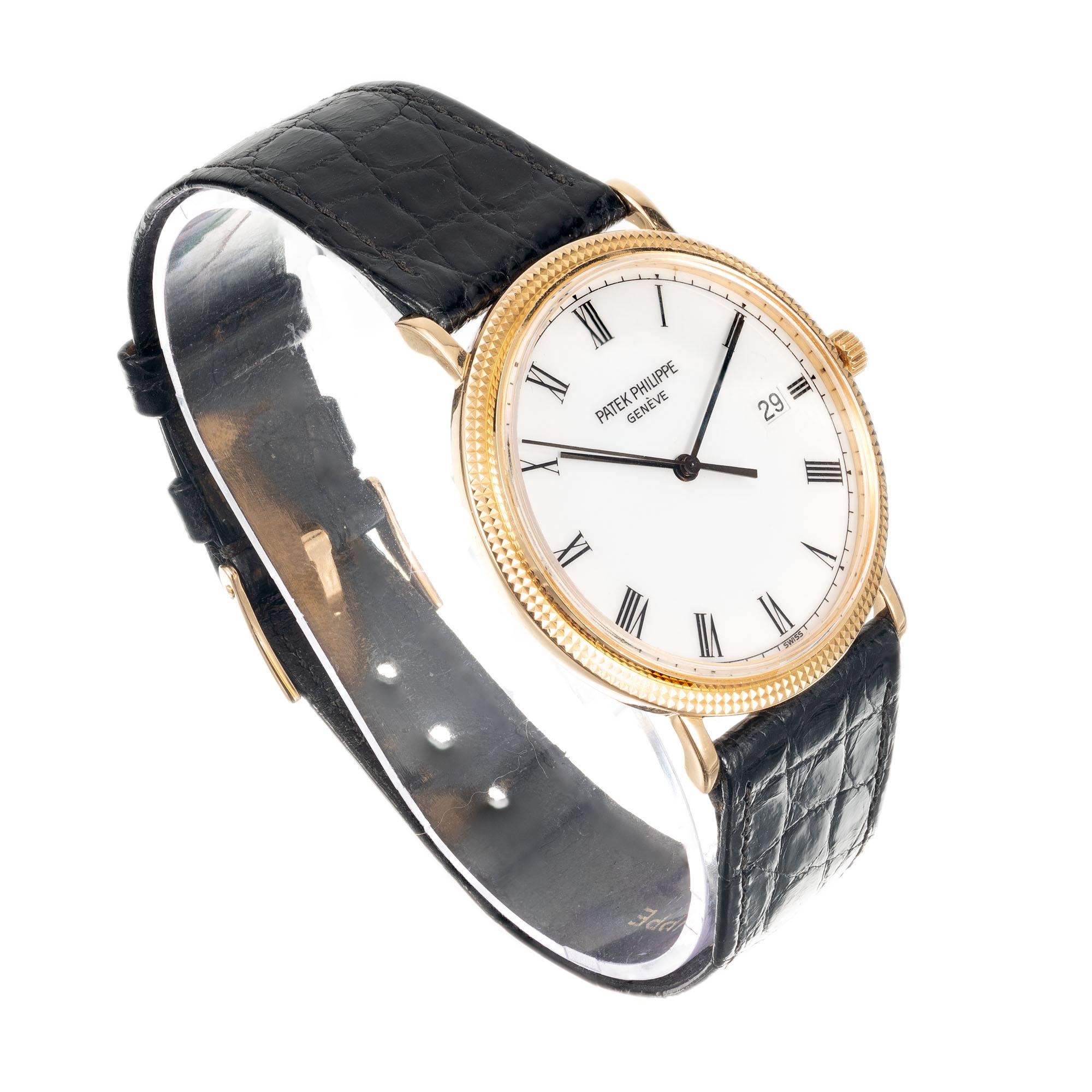 Patek Philipe 3944 hobnail Calatrava wristwatch in 18k solid yellow gold with 18k Patek buckle and black Patek Philippe band. White Patek dial with Roman numerals, date at 3 o’clock. Center sweep second hand.

Length: 37.29mm
Width: 33.33mm
Band