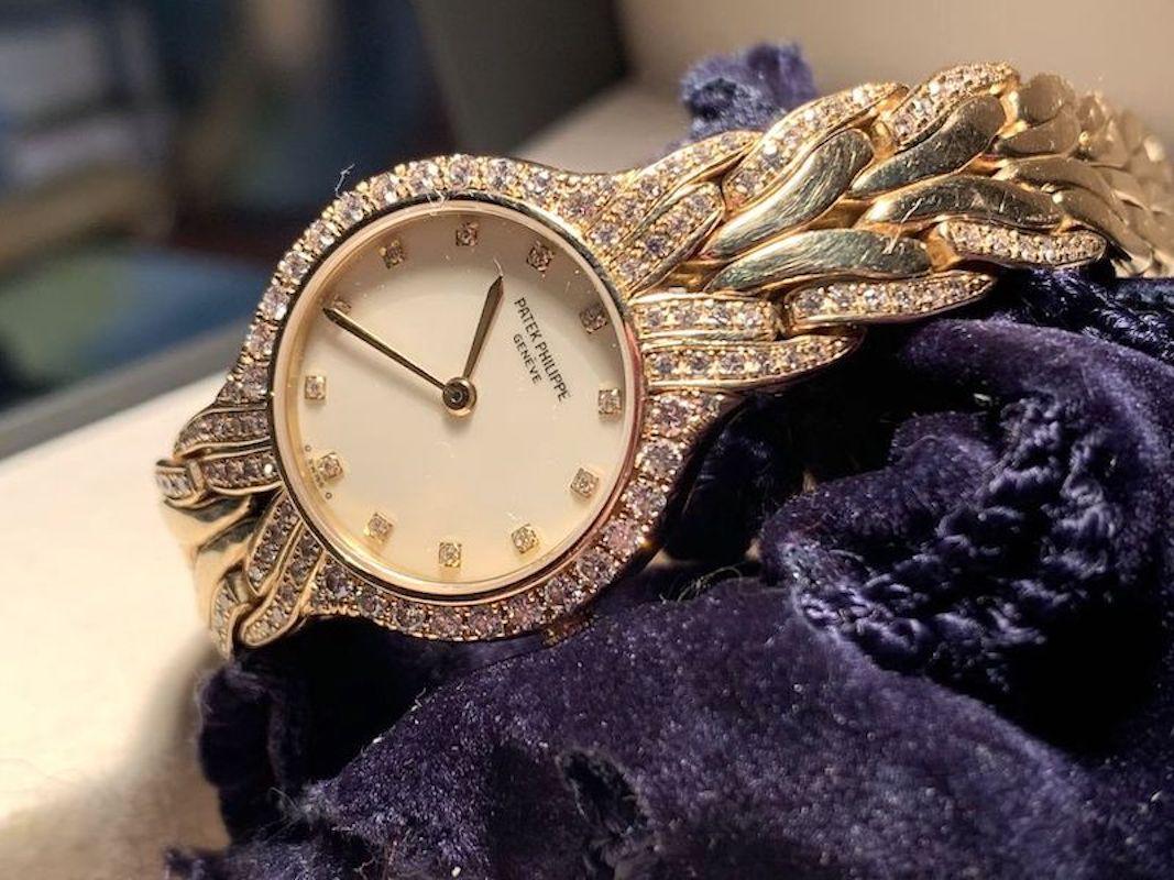 A Magnificent Patek Philippe La Flamme in 18 Karat Yellow Gold and diamond dial, diamond bezel and diamond lugs. 
Quartz. 23 mm case size. With box.
 Ref 4816/3. Fine Pre-owned Patek Philippe Watch. Certified preowned Dress Patek Philippe La Flamme