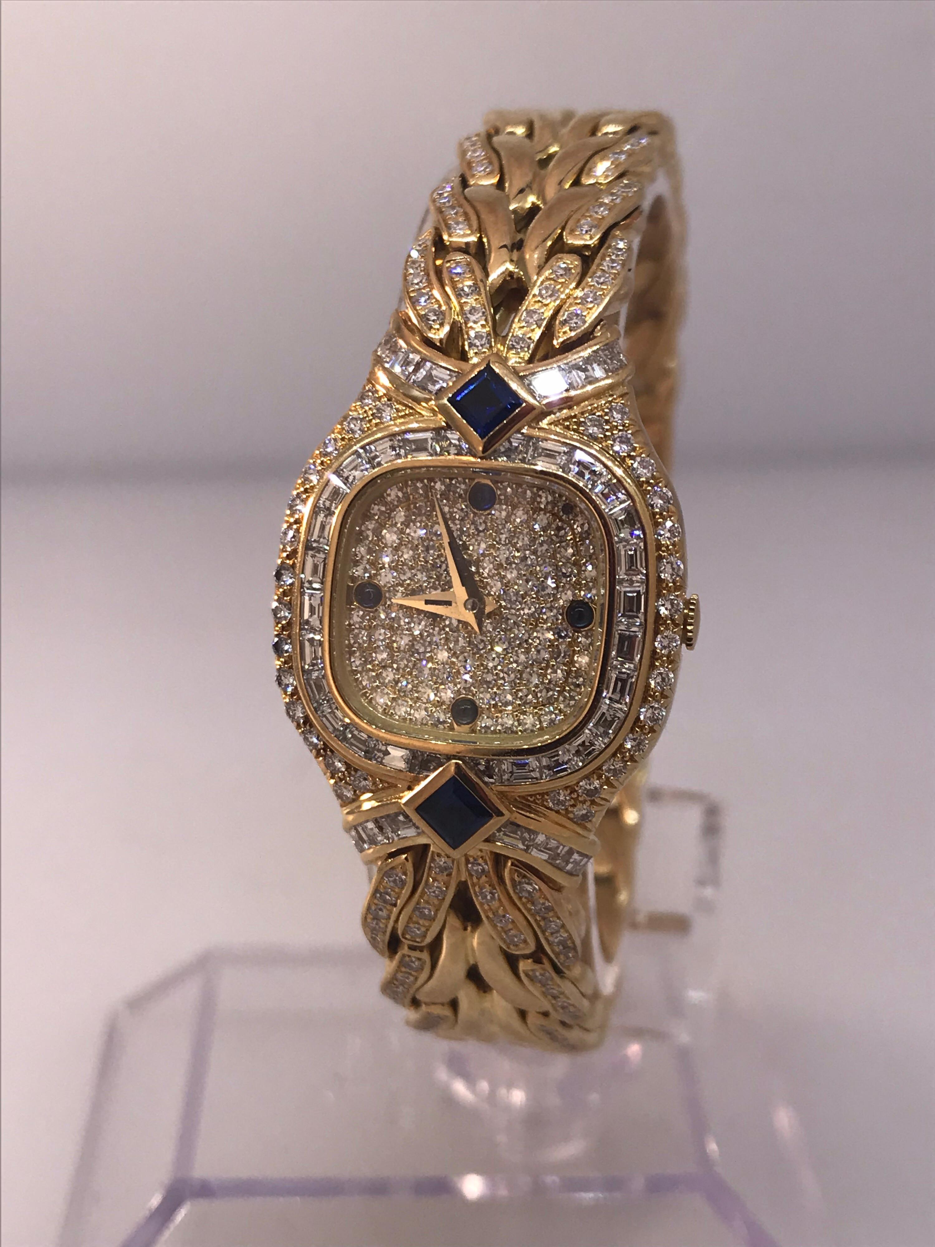 Patek La Flamme Ladies Watch

Model Number 4808

100% Authentic

New / Old Stock

Comes with a generic watch box

18 Karat Yellow Gold

Bezel set with:

	 40 Square cut diamonds (APPROX. 1.40 Carats)
	 2 Large square cut blue sapphires (APPROX .37