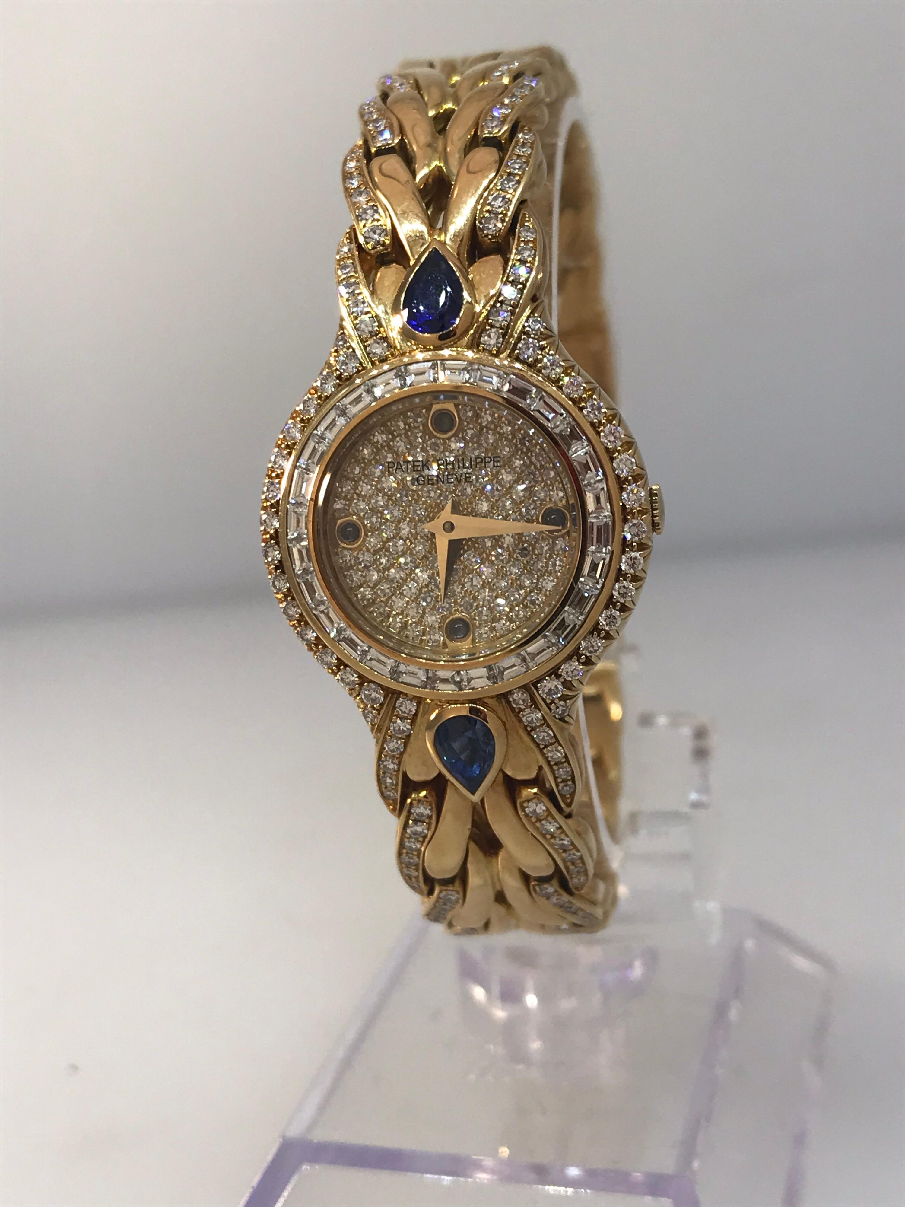 Patek La Flamme Ladies Watch

Model Number 4808

100% Authentic

New / Old stock

Comes with a generic watch box

18 Karat Yellow Gold

Bezel set with:

	 Square cut diamonds 
	 2 Large blue sapphires 
	 Round diamonds 

Pave Diamond dial with blue