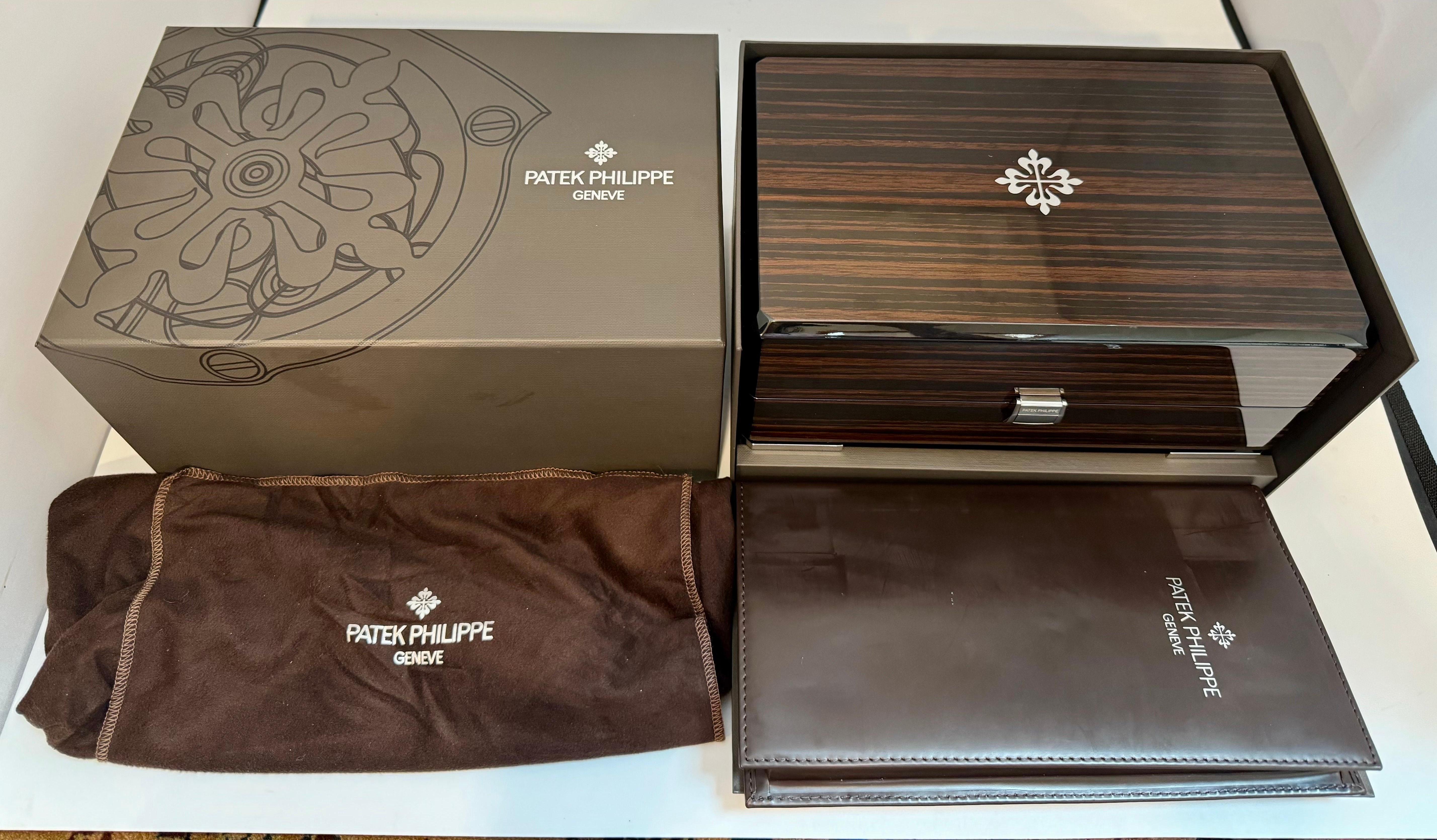 Patek Philippe lacquered wood Swiss watch Presentation Box. Brand New 
No scratches 
It features a hinged front lock closure with metal hardware and an inlaid maker’s logo on the lid.
The interior is lined with beige soft leather and includes a