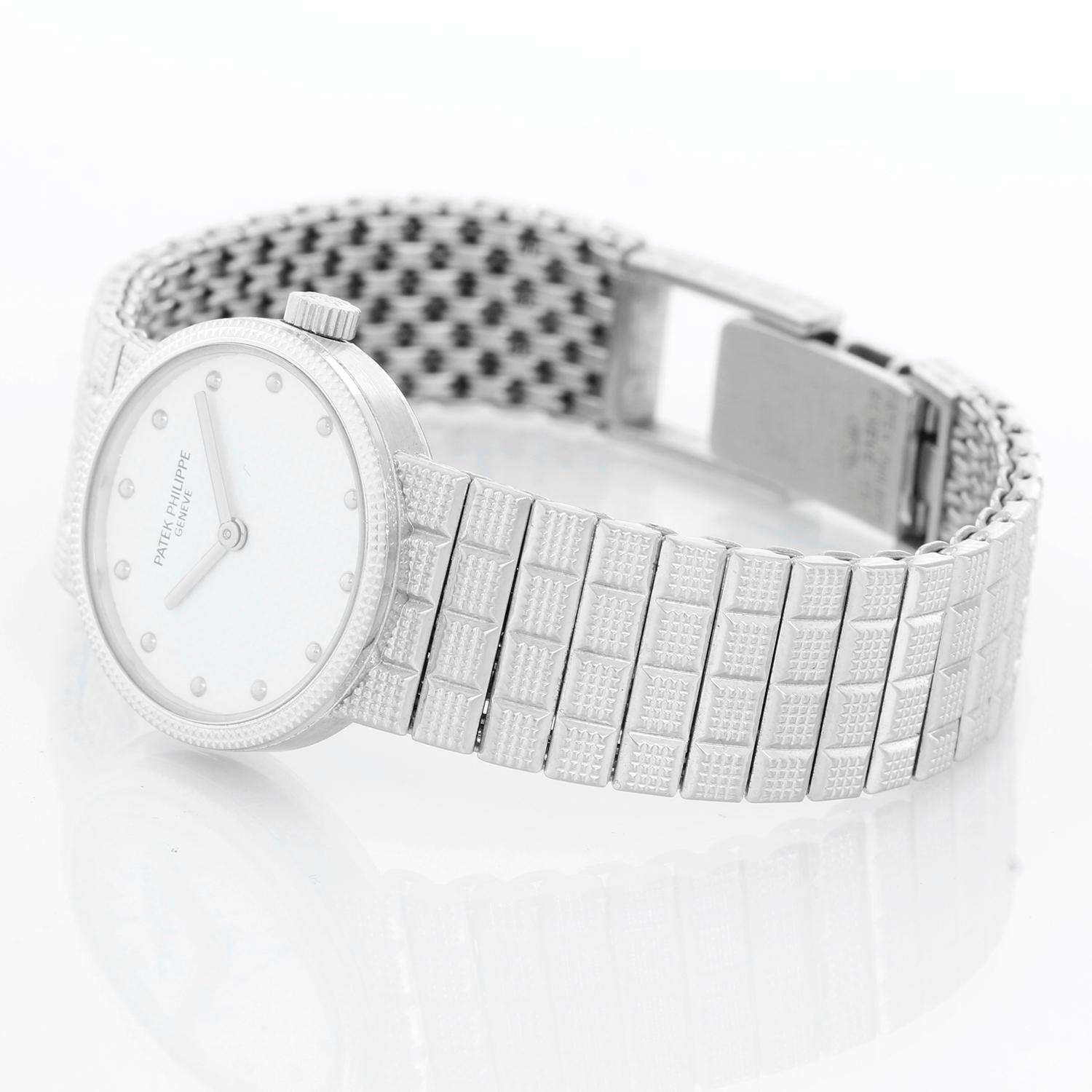 Patek Philippe Ladies Calatrava 18K White Gold Watch 4596/010 - Manual winding. 18K White gold with hobnail bezel ( 26 mm ). White dial with hobnail hour markers. 18k gold Patek Philippe Clou de Paris bracelet; will fit up to a 5 1/2 inch wrist.