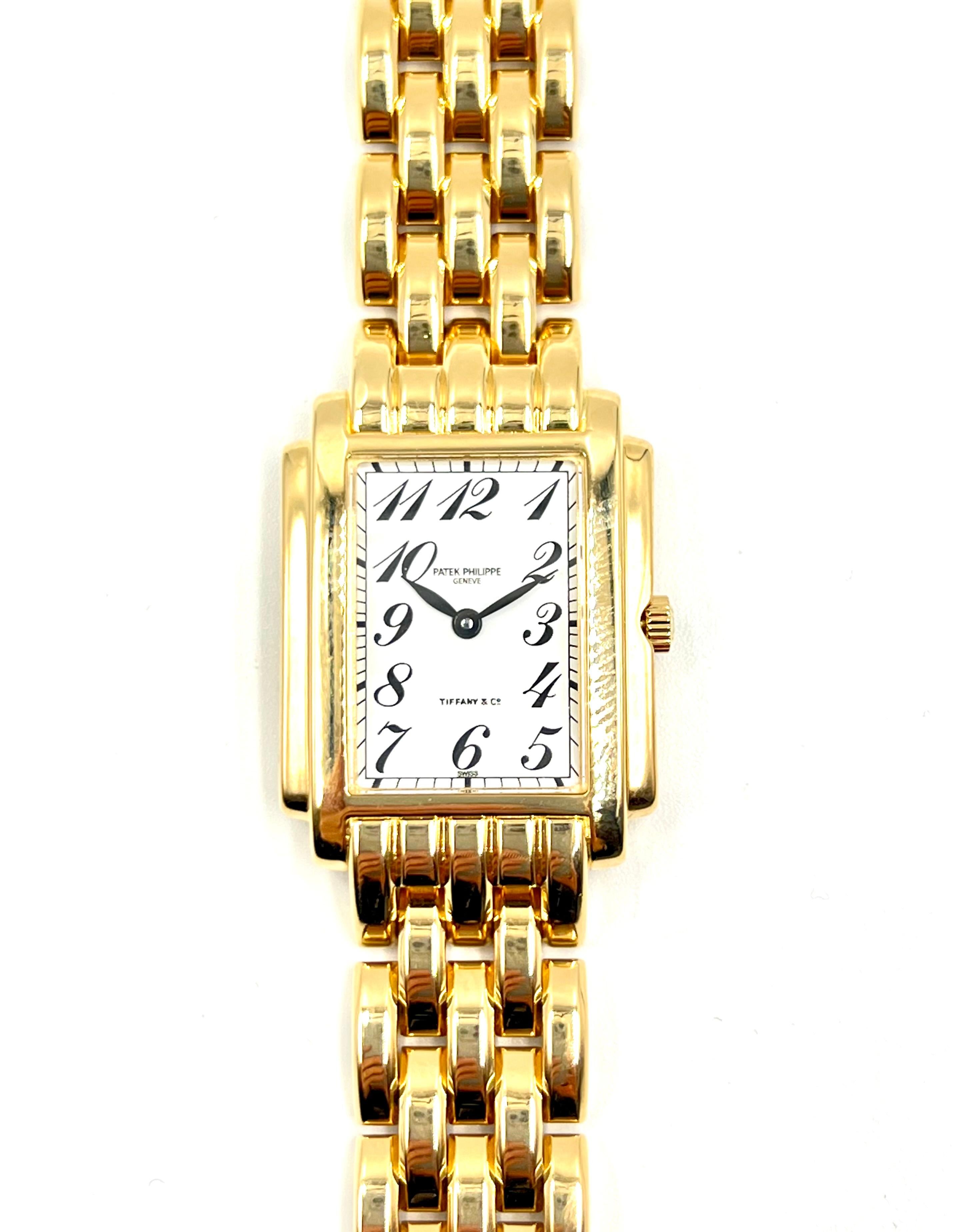 Pre-owned Patek Philippe Ladies' Gondolo wristwatch (ref. 4824/1J), featuring a Swiss-made quartz movement; white dial signed TIFFANY & CO with painted black Arabic numerals; and 22 x 29mm, cambered rectangular 18k yellow gold case on the Patek 18k