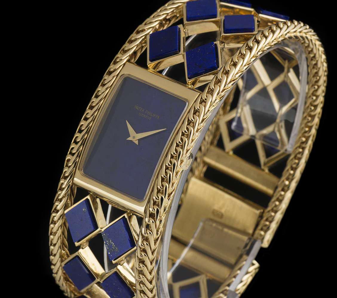 A Rare Yellow Gold Ladies Vintage Wristwatch, lapis lazuli dial, a fixed yellow gold polished bezel, a yellow gold fancy bracelet set with 22 lapiz lazuli panels, a brushed yellow gold jewellery style clasp, sapphire glass, manual wind movement, in